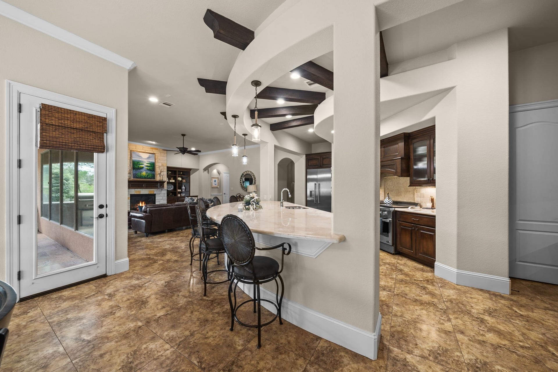 4426 Silver Jade Drive, Spring, TX 77386 A show-stopping workspace. A massive marble island complete with an integrated sink, elegant pendant lighting, and plenty of bar seating for casual family meals.