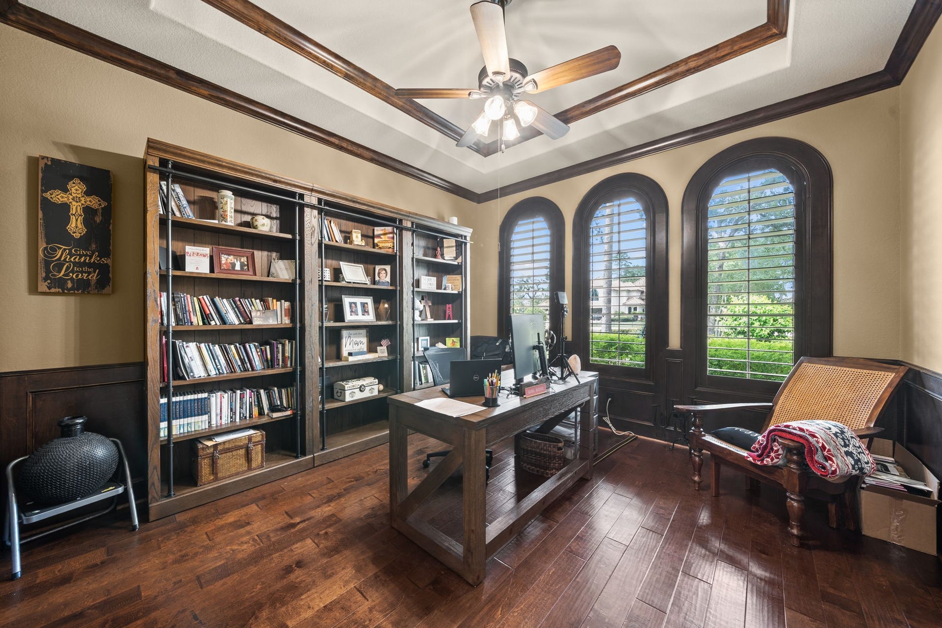 4426 Silver Jade Drive, Spring, TX 77386 A masterclass in home office design. Making a sophisticated statement just off the foyer, this distinguished workspace showcases hand-laid wood flooring, exquisite architectural millwork, and an elegant tray ceiling that elevates the entire room into a premier professional retreat.