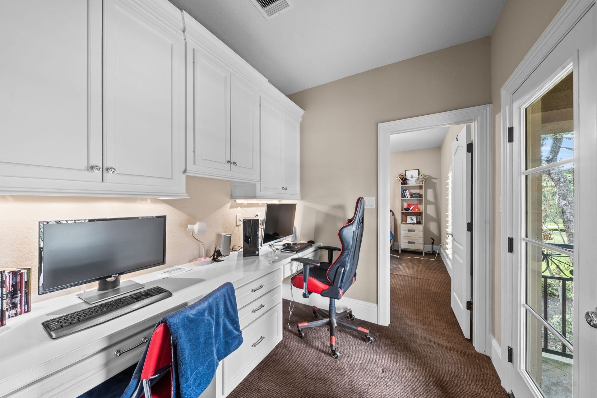 4426 Silver Jade Drive, Spring, TX 77386 Tucked conveniently between the bedrooms, this brilliant bonus space offers the perfect quiet study or additional work area, complete with extensive storage and custom built-in desks.