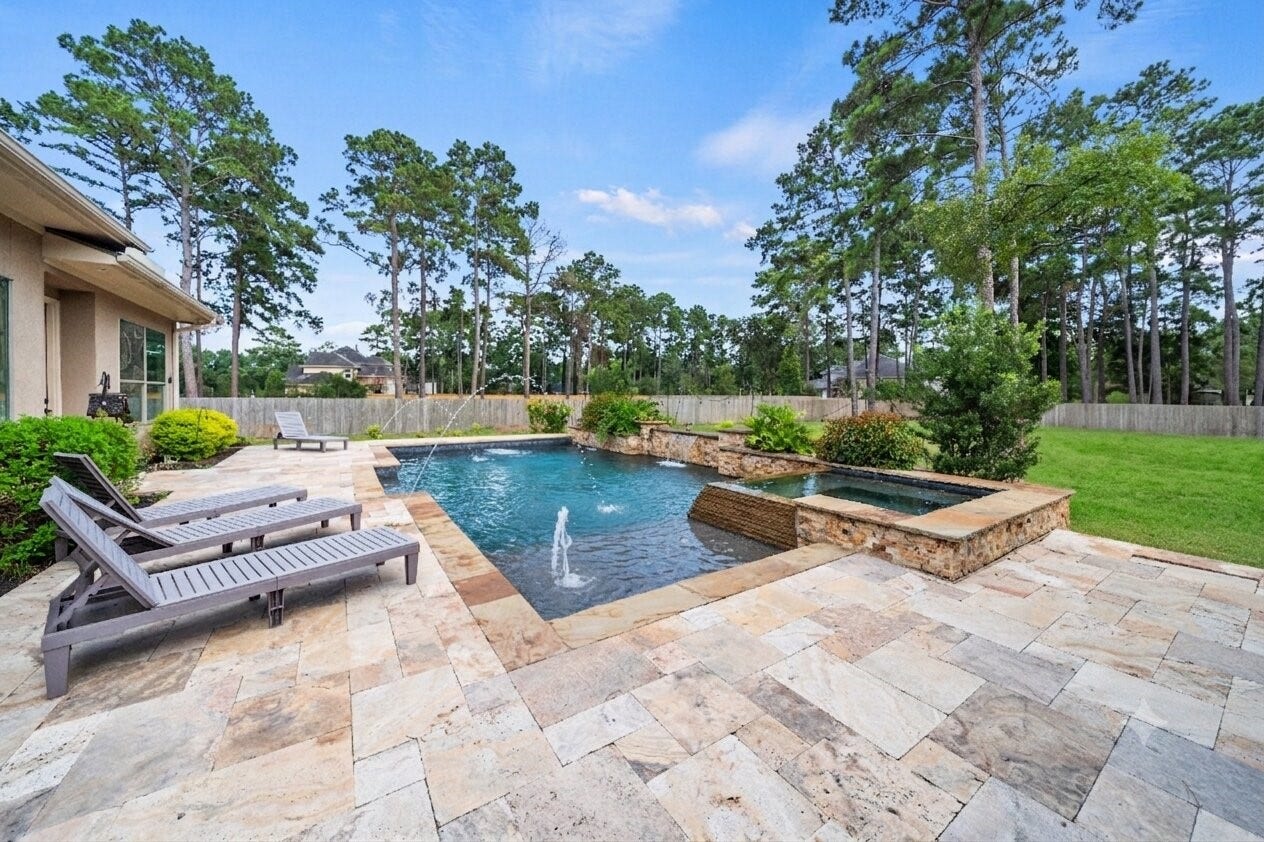 4426 Silver Jade Drive, Spring, TX 77386 An extraordinary open-air sanctuary designed for ultimate recreation and relaxation. Submerge yourself in the heated spa on a cool evening or enjoy a midnight swim, all while enveloped in the soothing acoustics of architectural stacked-stone waterfalls.