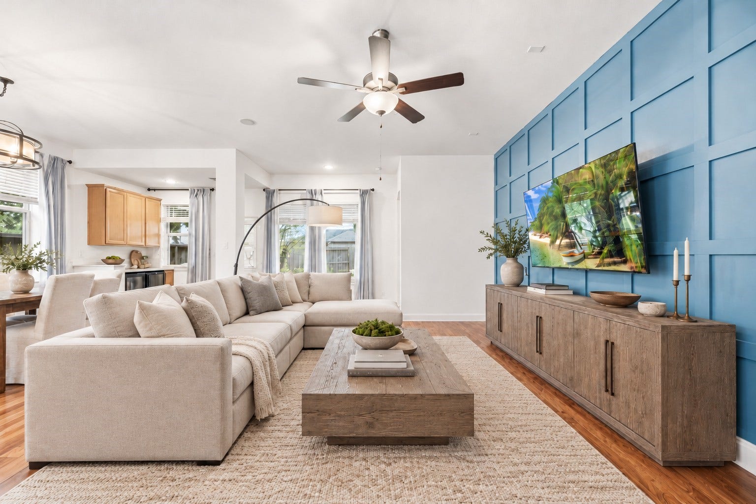 18203 Burnett Willow Lane, Cypress, TX 77433 living area with a stylish blue accent wall, this cozy open layout flows into a bright dining and kitchen space, perfect for entertaining. Virtually Staged