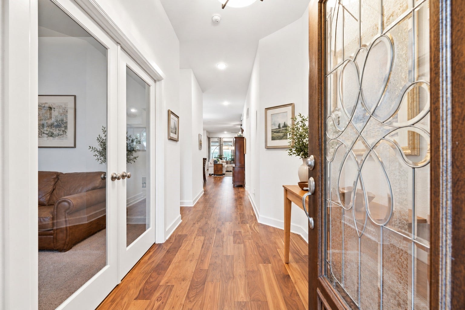 18203 Burnett Willow Lane, Cypress, TX 77433 Inviting entryway through the elegant glass doors, warm wood floors. Virtually Staged