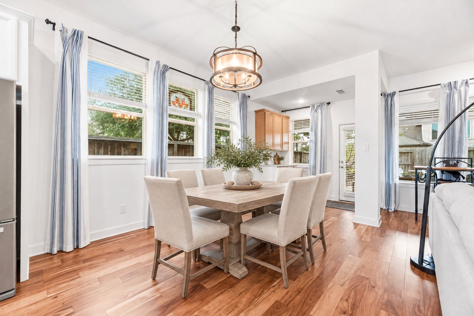18203 Burnett Willow Lane, Cypress, TX 77433 Bright and inviting breakfast/dining area features rich hardwood floors, abundant natural light from large windows, seamlessly connected to a cozy kitchen space. Virtually Staged