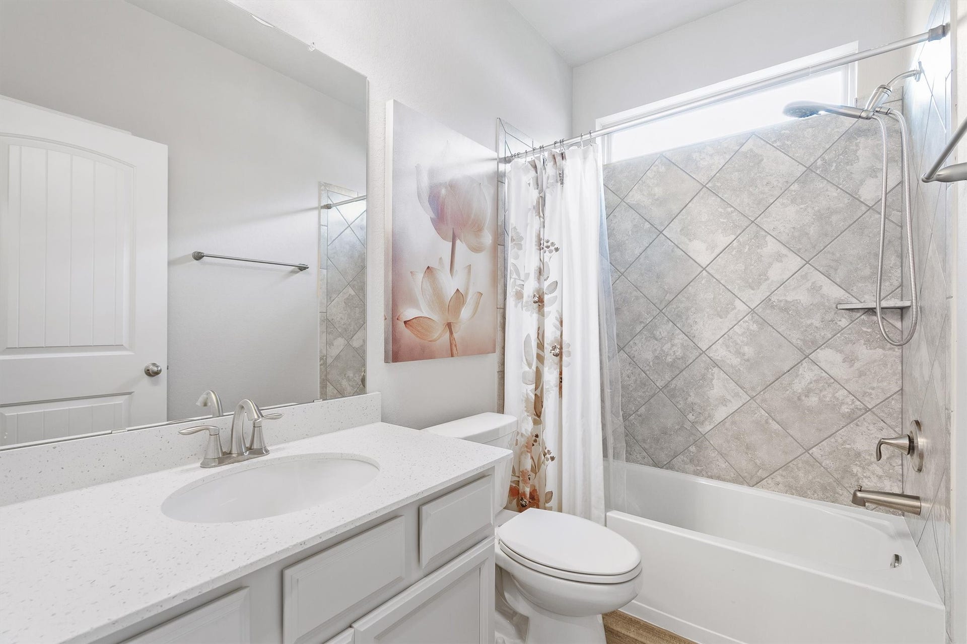9034 Japonica Drive, Rosenberg, TX 77469 Bright and modern bathroom with elegant tilework, a sleek vanity, and a clean shower-tub combo, perfect for relaxation and style.