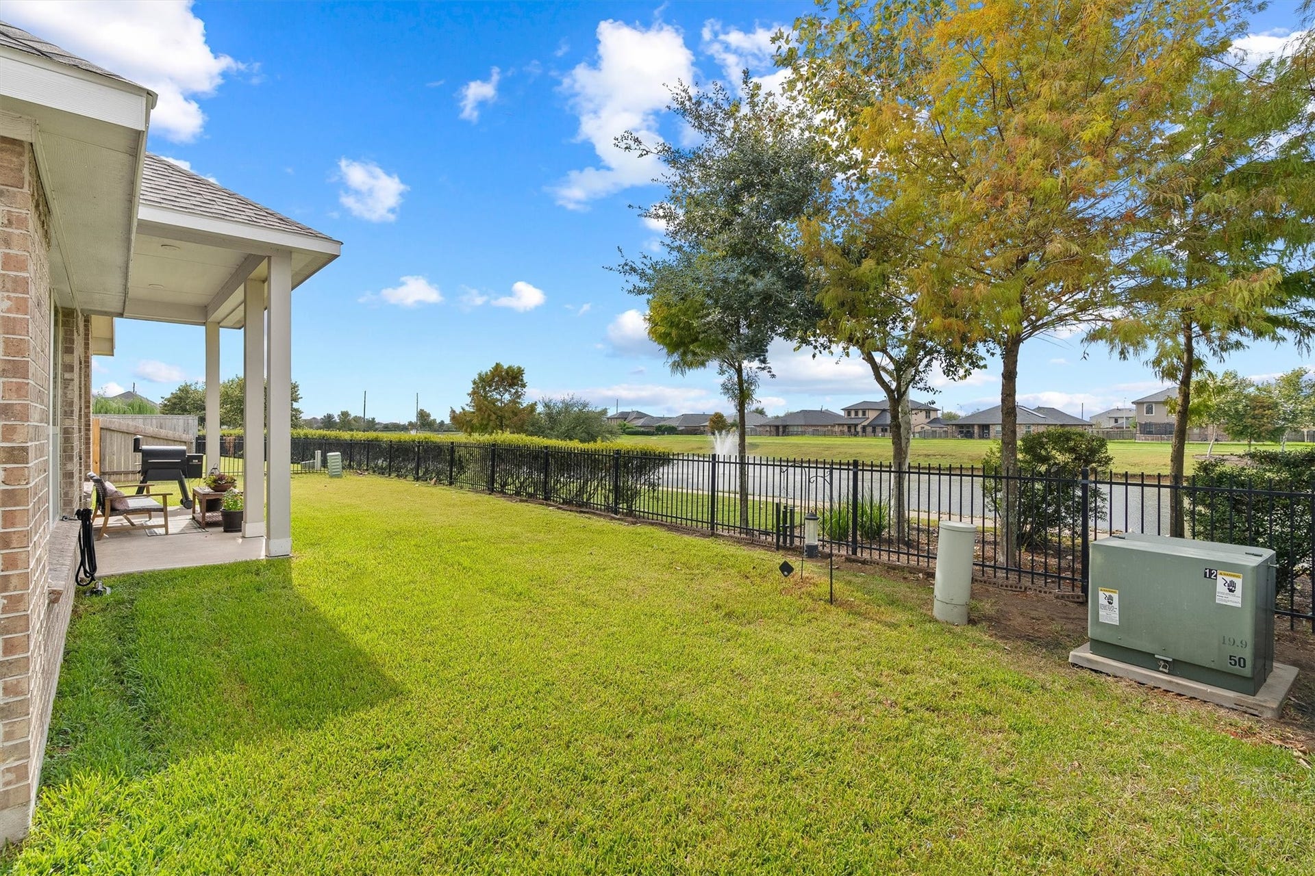 9034 Japonica Drive, Rosenberg, TX 77469 Enjoy endless outdoor living with a covered patio, sprawling lawn, and direct views of the neighborhood lake.