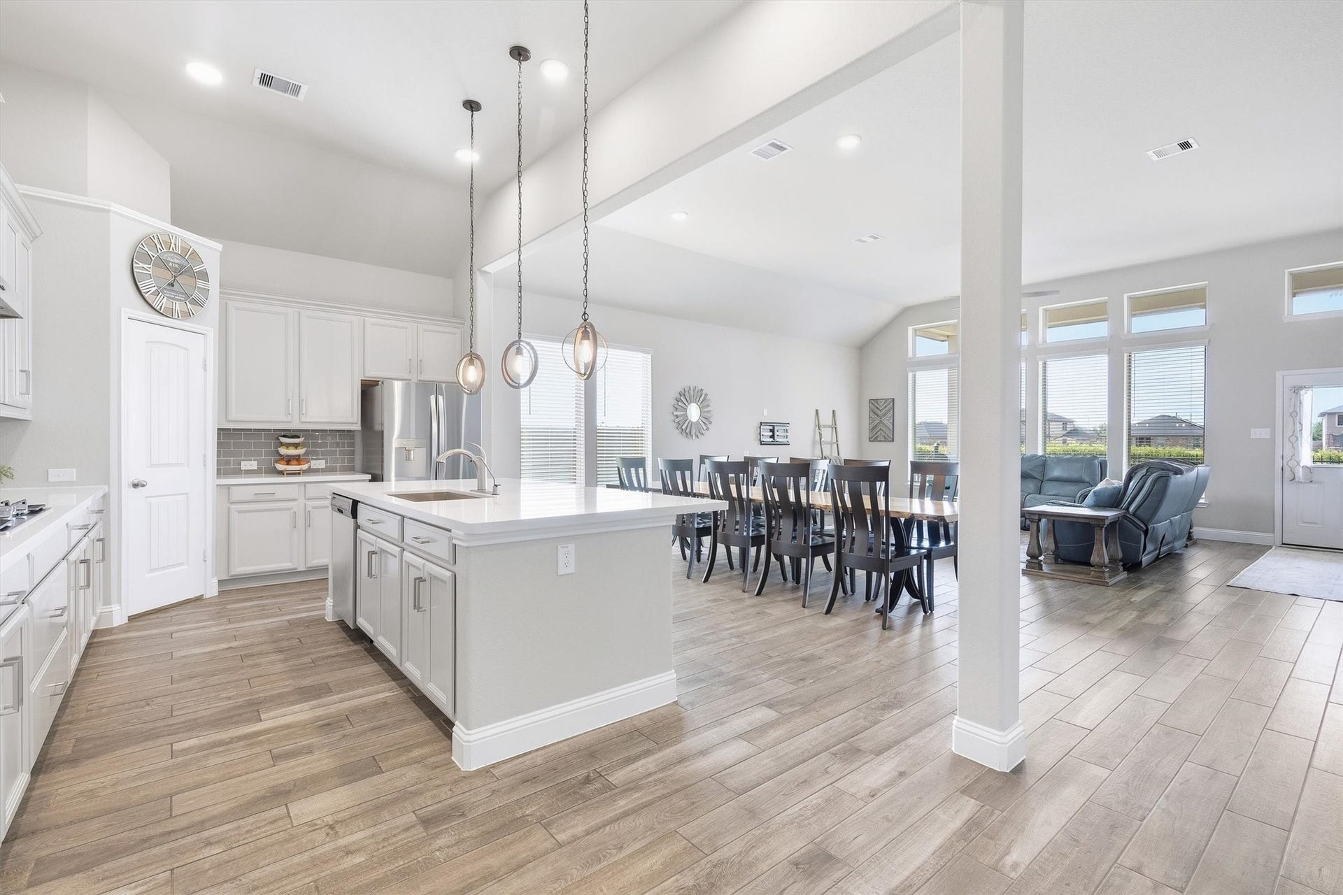 9034 Japonica Drive, Rosenberg, TX 77469 Step inside your modern dream home featuring a pristine white kitchen and a classic gray subway tile backsplash.