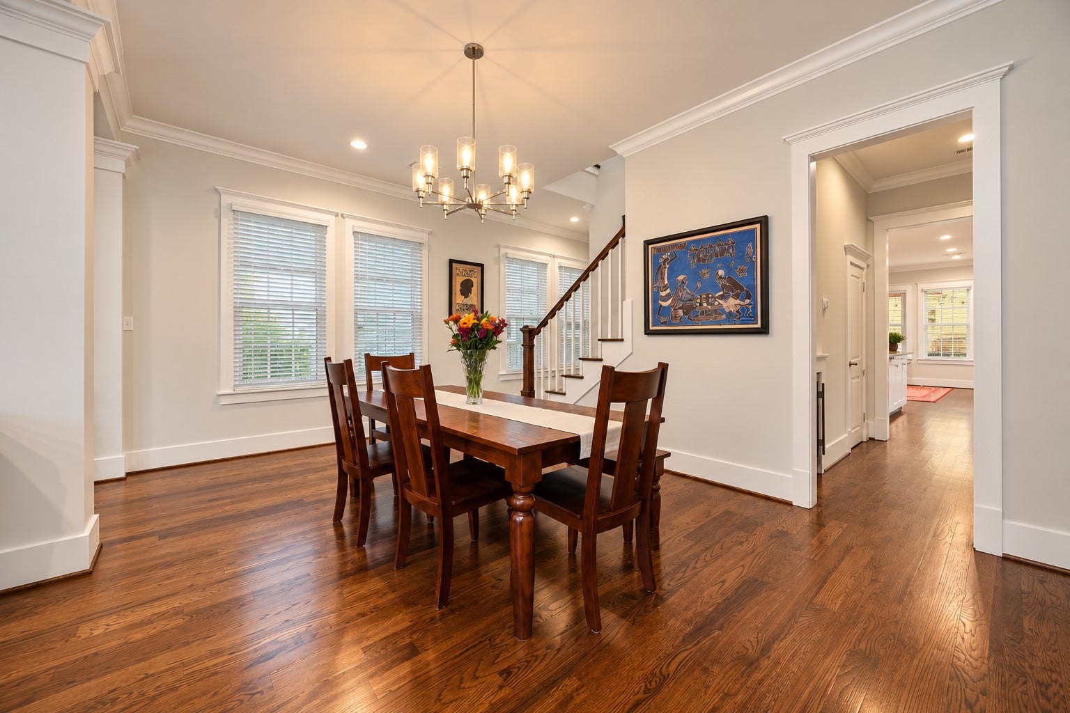 Beautiful hardwood floors and modern lighting complement the spacious dining area.