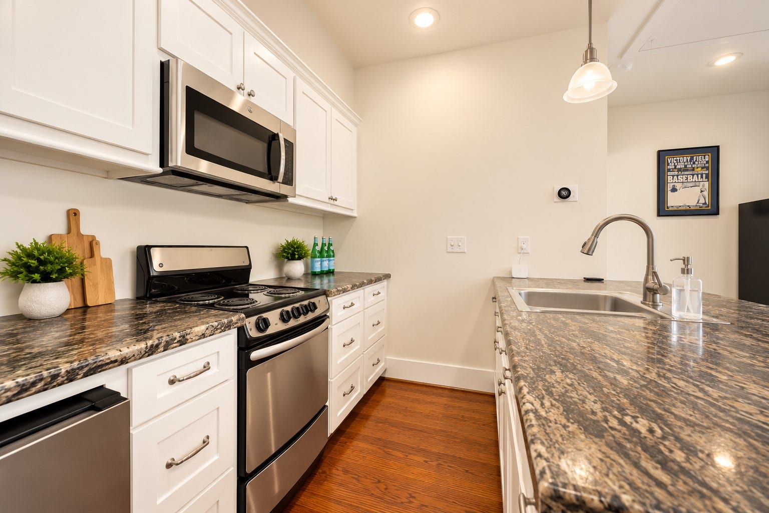 Fully equipped apartment kitchen offers stainless appliances, generous counter space & ample cabinetry.