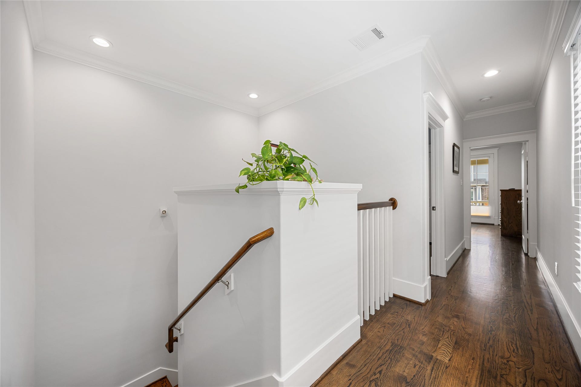 Upstairs with hardwood floors connects the bedrooms, bathrooms.