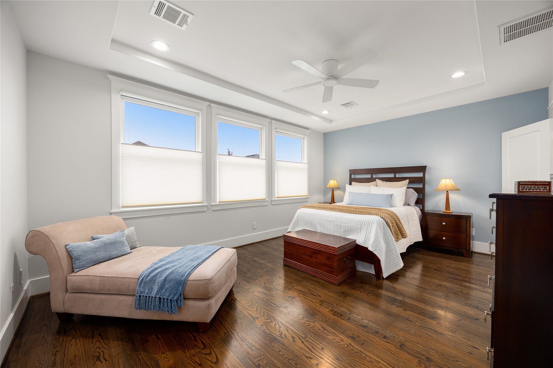 Spacious 2nd-floor primary suite features hardwood floors, abundant natural light & room for a sitting area.