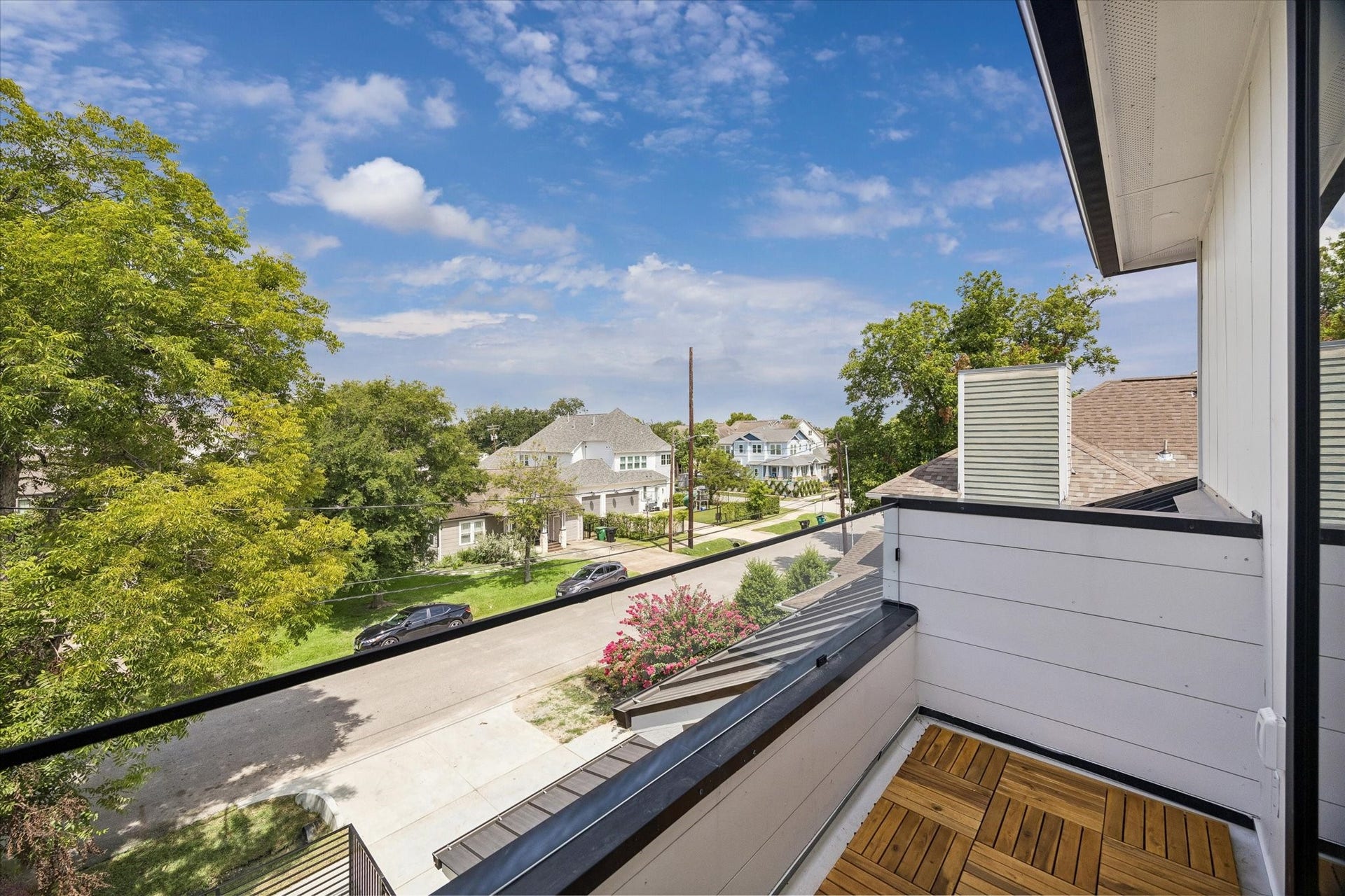 Spacious garage with sleek epoxy flooring, bright LED lighting, and a modern automatic door system with windows.
