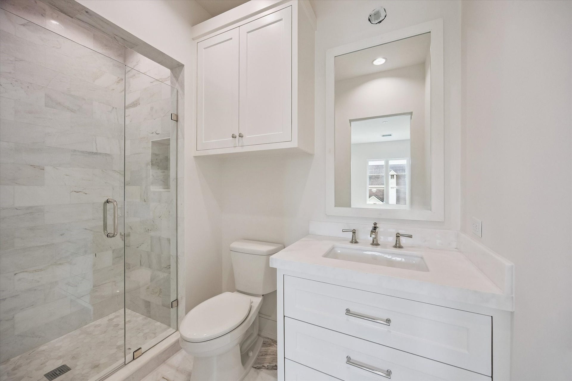 Three en suite baths with solid marble counters and tile. Lighting above the mirrors not yet installed.