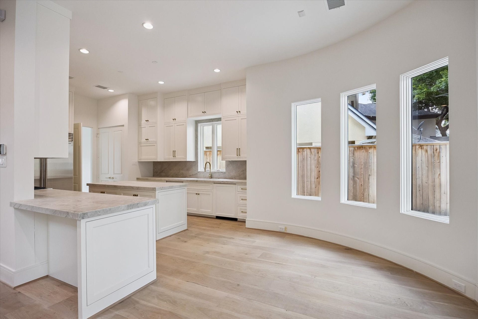 Breakfast room and island kitchen.  Decorative lighting not yet installed.