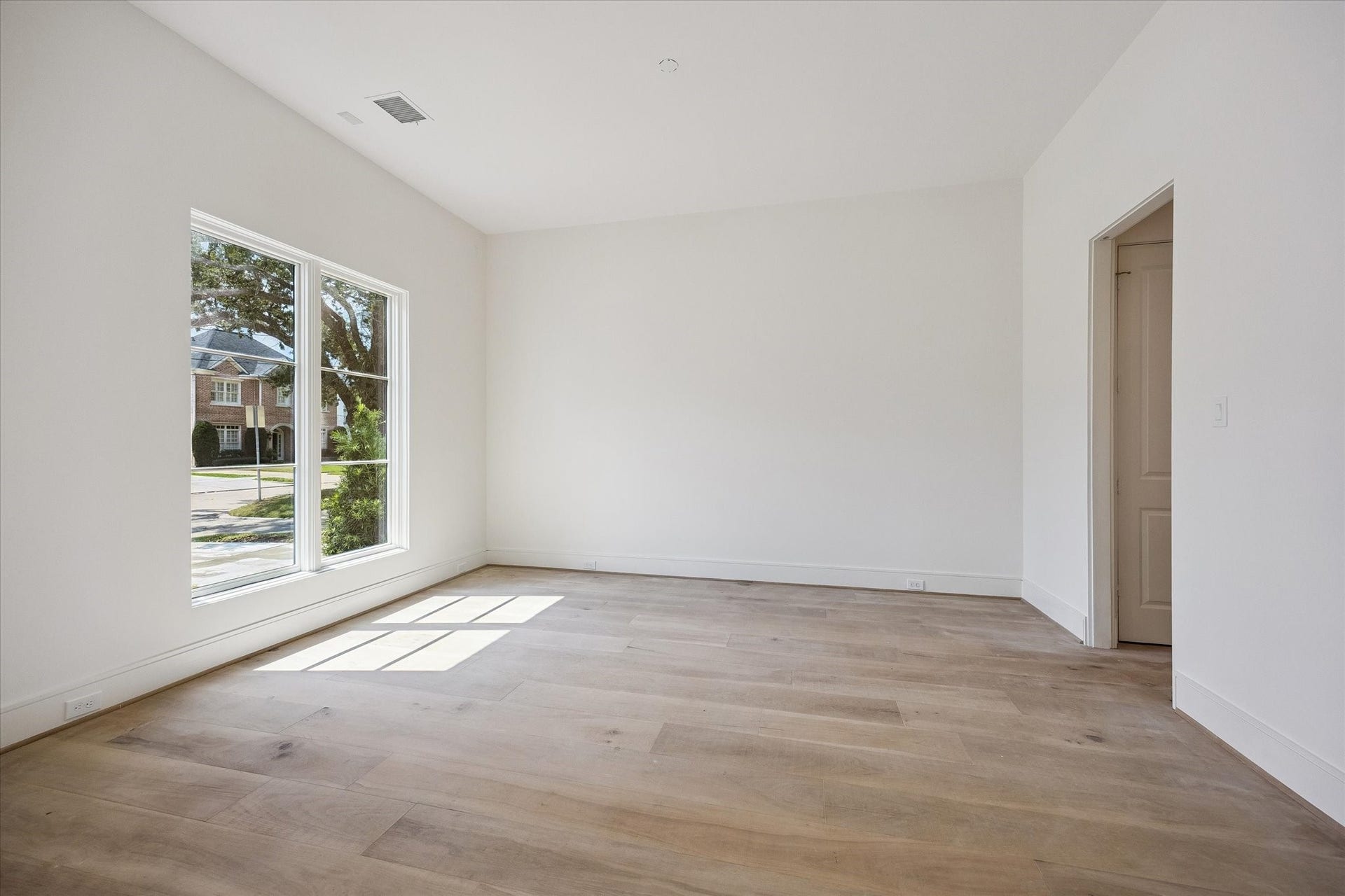 Dining room with dual action door to kitchen.  Chandelier not yet installed.