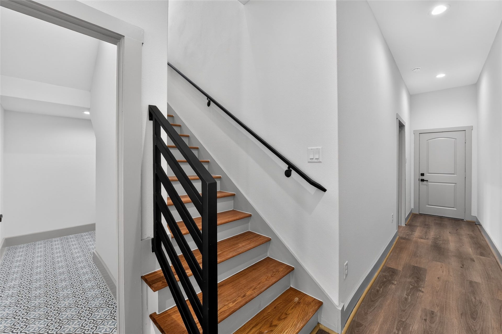 A gracefully integrated half bath sits discreetly tucked beside the staircasea clever, space-efficient luxury offering guest convenience.