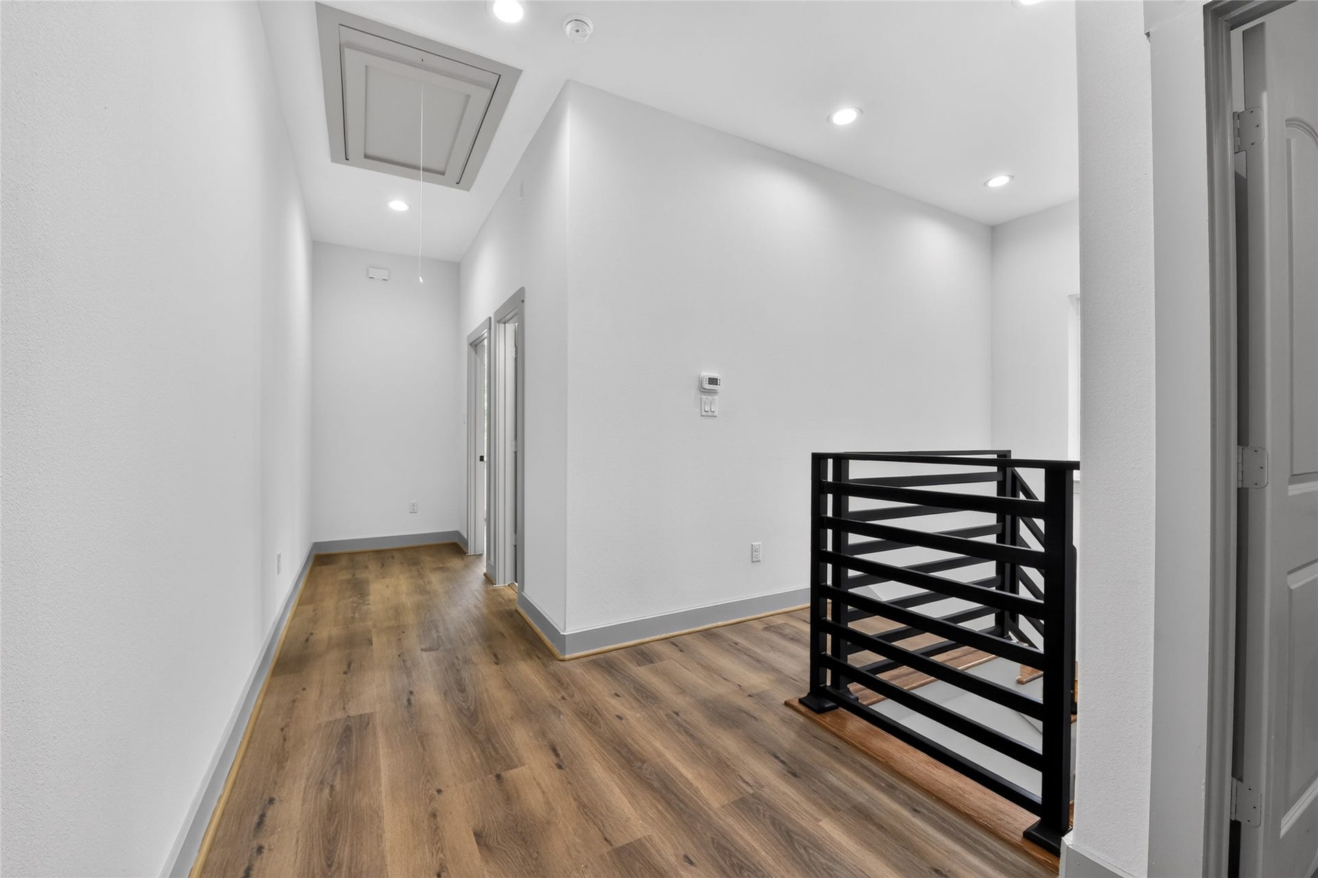 A clean hallway connects two spacious bedrooms and a dedicated full bathcompletely carpet-free for low-maintenance living.