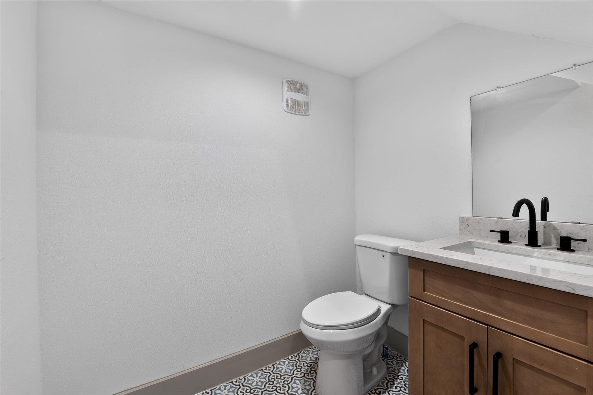 A refined first-floor powder room has ample room to breathe.