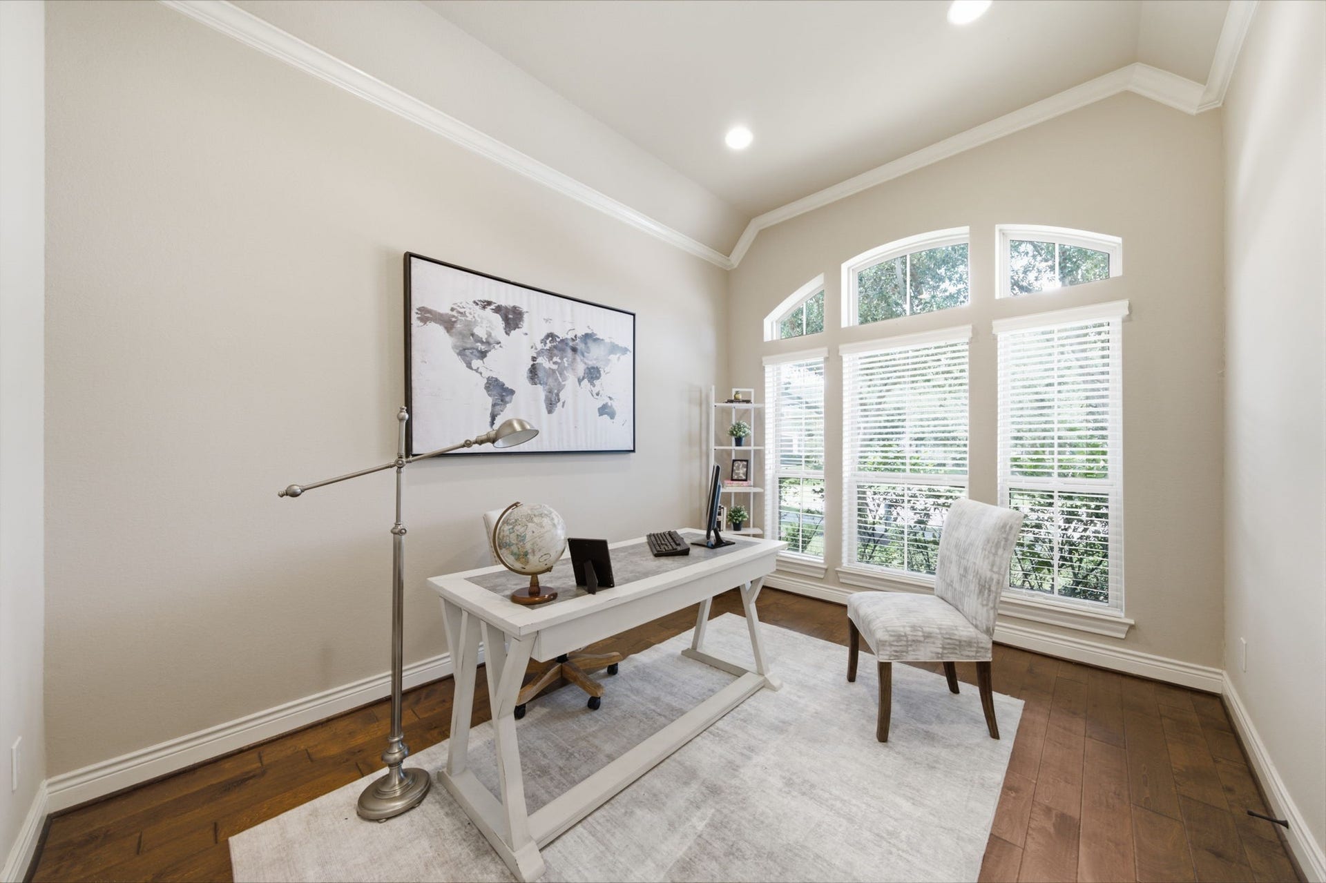 4603 Piper Shadow Lane, Katy, TX 77494 Bright and inviting home office with large arched windows, elegant hardwood floors, and stylish decor, perfect for productivity.