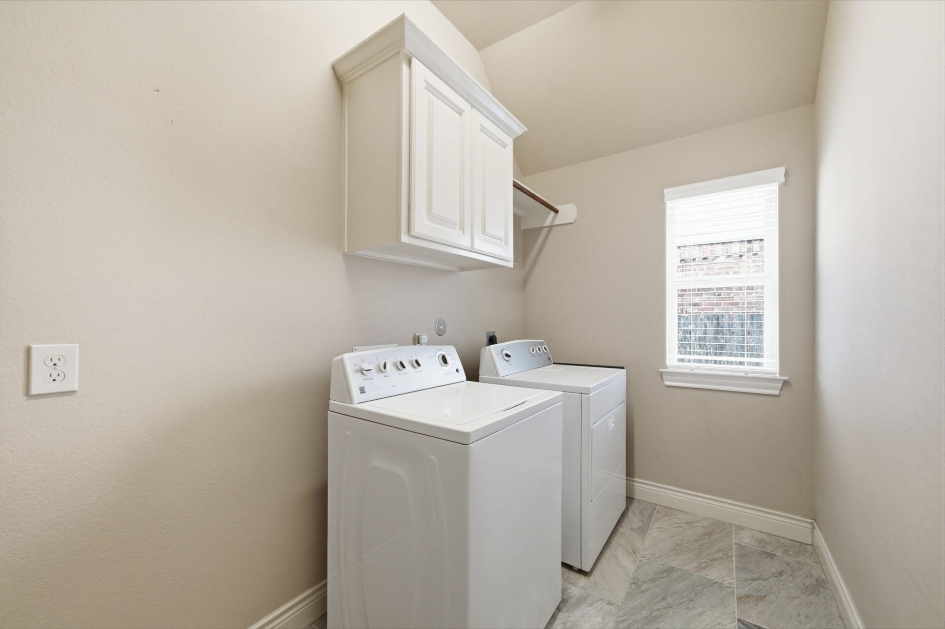 4603 Piper Shadow Lane, Katy, TX 77494 Bright and functional laundry room featuring modern appliances, ample cabinetry, and a window for natural light.