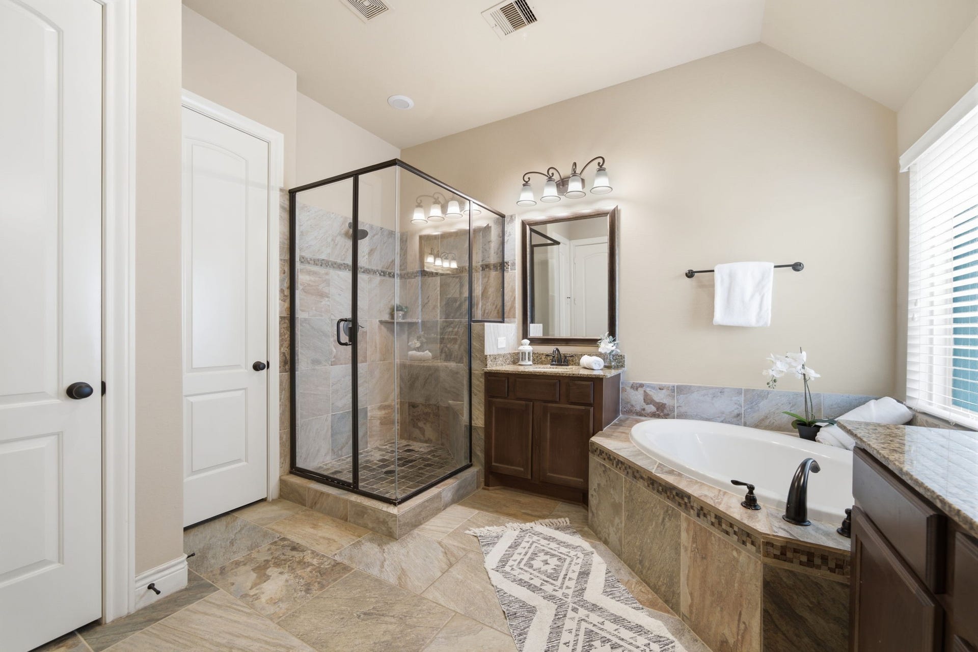 4603 Piper Shadow Lane, Katy, TX 77494 Luxurious bathroom featuring a spacious glass-enclosed shower, elegant soaking tub, and stylish vanity with ample storage.