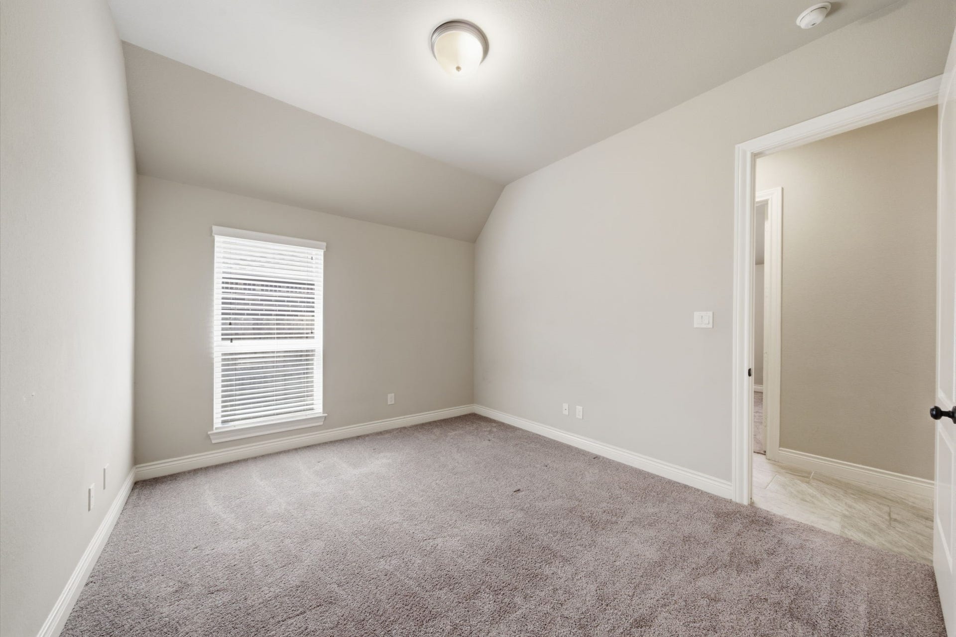 4603 Piper Shadow Lane, Katy, TX 77494 Cozy bedroom with soft carpeting, neutral walls, and a large window providing ample natural light.
