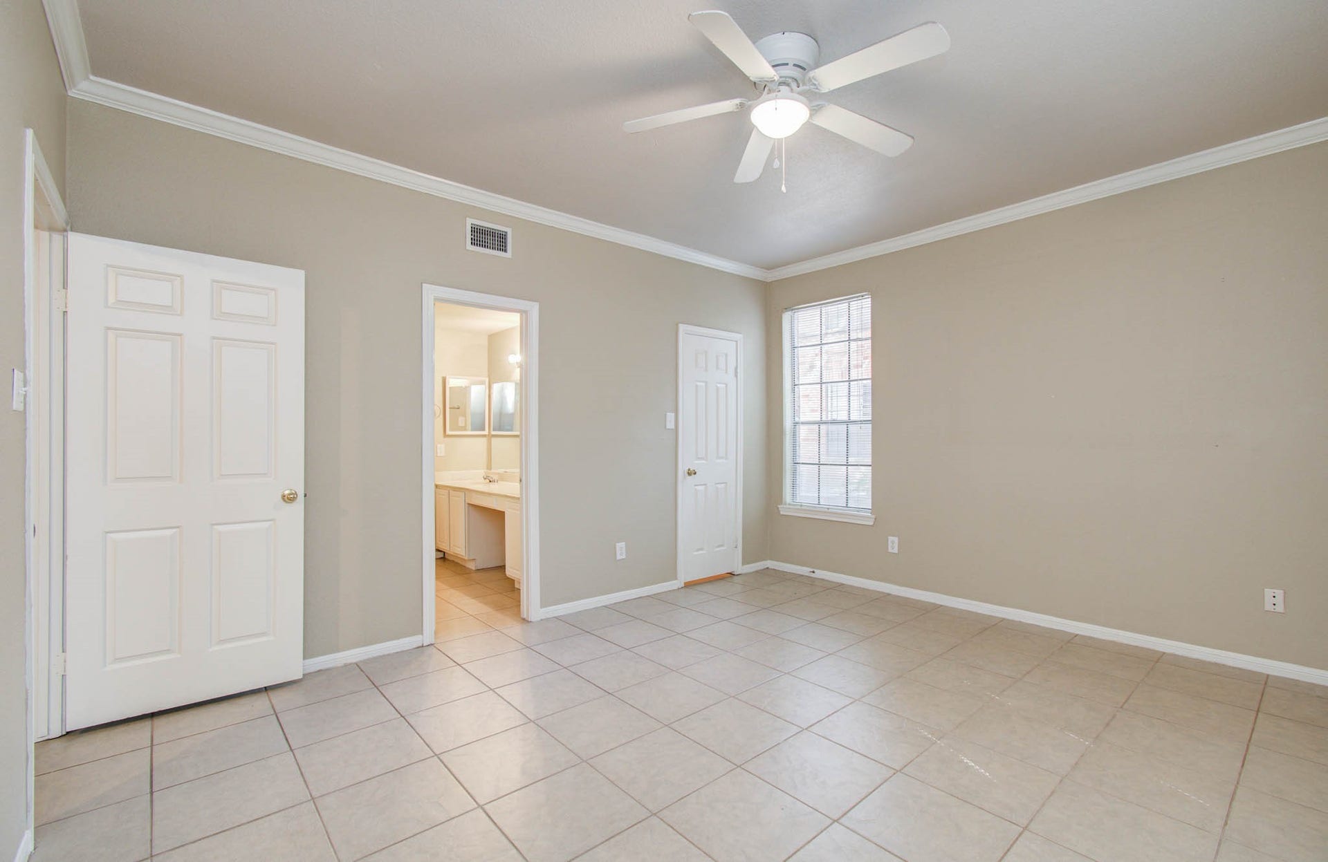 Another view of bedroom featuring en-suite bathroom.
