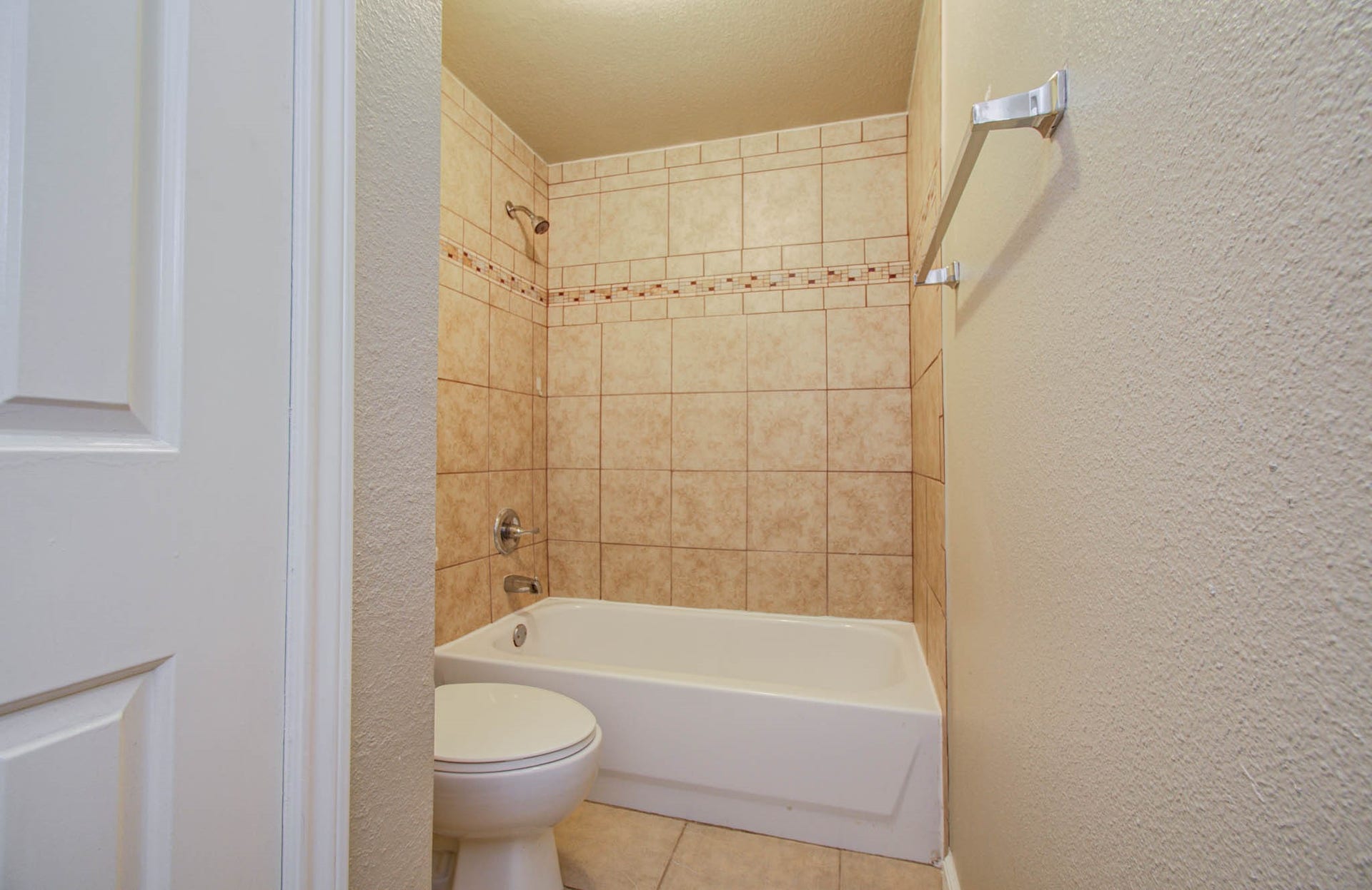 This bathroom features a bathtub shower combo