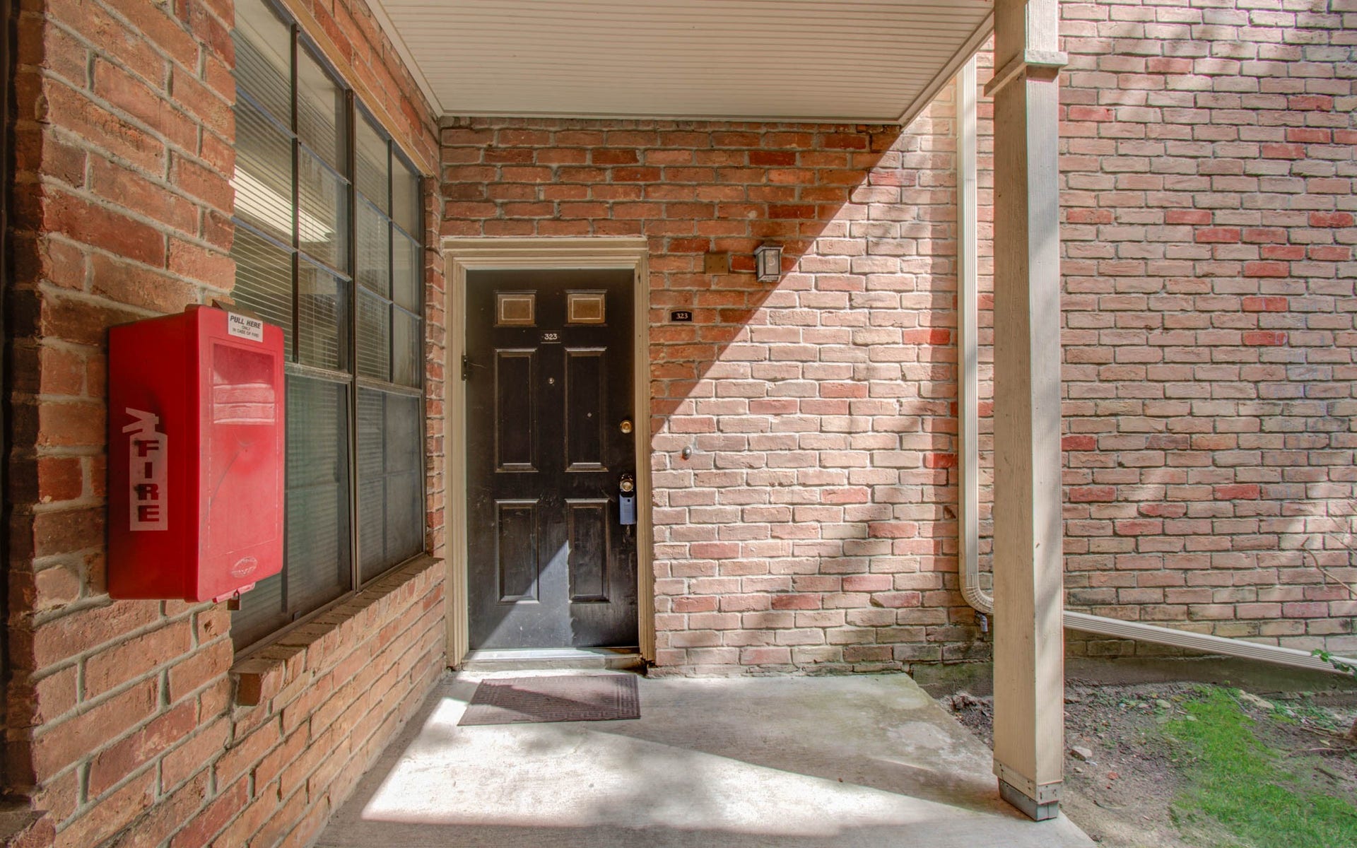 View of condo front door and entryway
