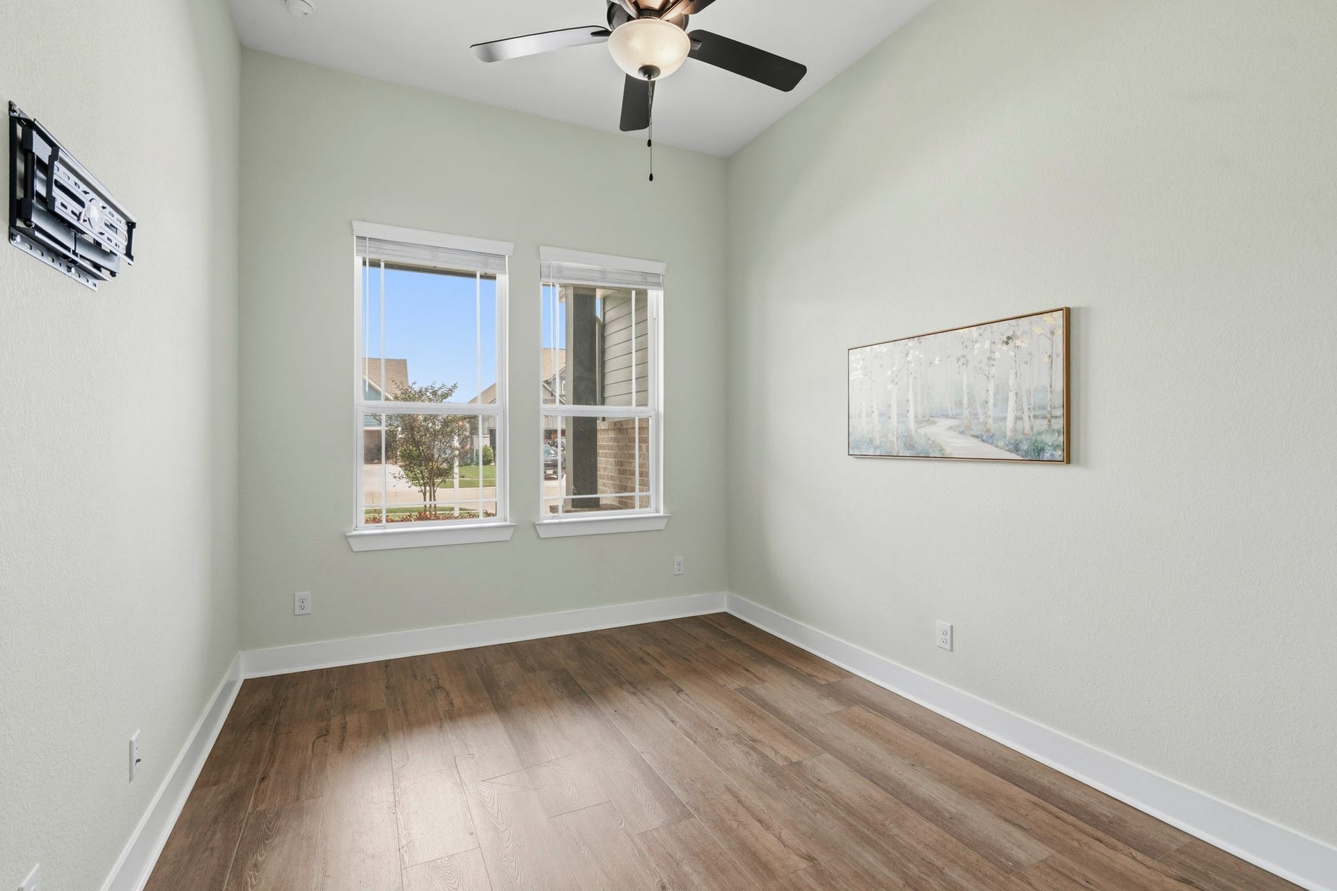 Perfectly positioned quietly tucked off the Foyer at the front of the home, is the Guest Bedroom. It offers both comfort and privacy with its own Ensuite Bath and is completed with LVP floors, upgraded ceiling fan, custom paint, installed TV bracket and a walk-in Closet.