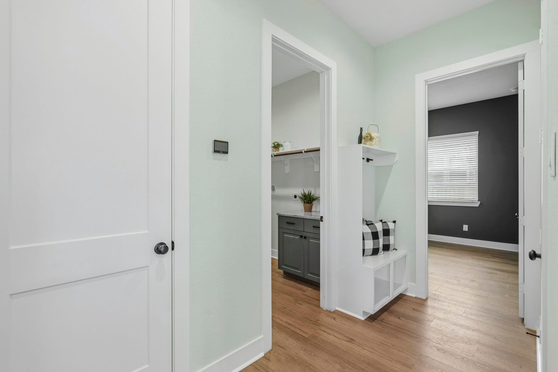 Located off the access to the Utility Room and the 2-car Garage sits this well-appointed Mud Room that provides a well desired drop zone for coats, backpacks, and keys. The closed door to the left leads to the Powder Room, followed by the Laundry Room, and then the Media Room.