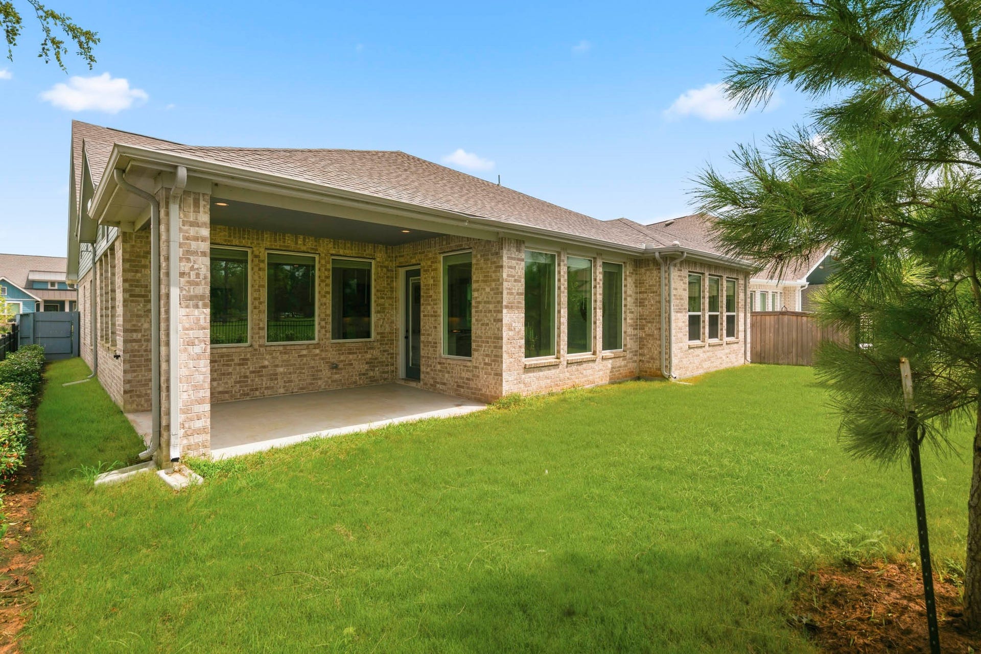 This covered Porch is inset under the roof line and provides a stronger look along with better shelter from the elements and shade from the hot sun. Whether furnished with cozy lounge seating for morning coffee or an outdoor dining table for gatherings, this inviting outdoor space allows you to enjoy the beauty of nature just beyond your Backyard.