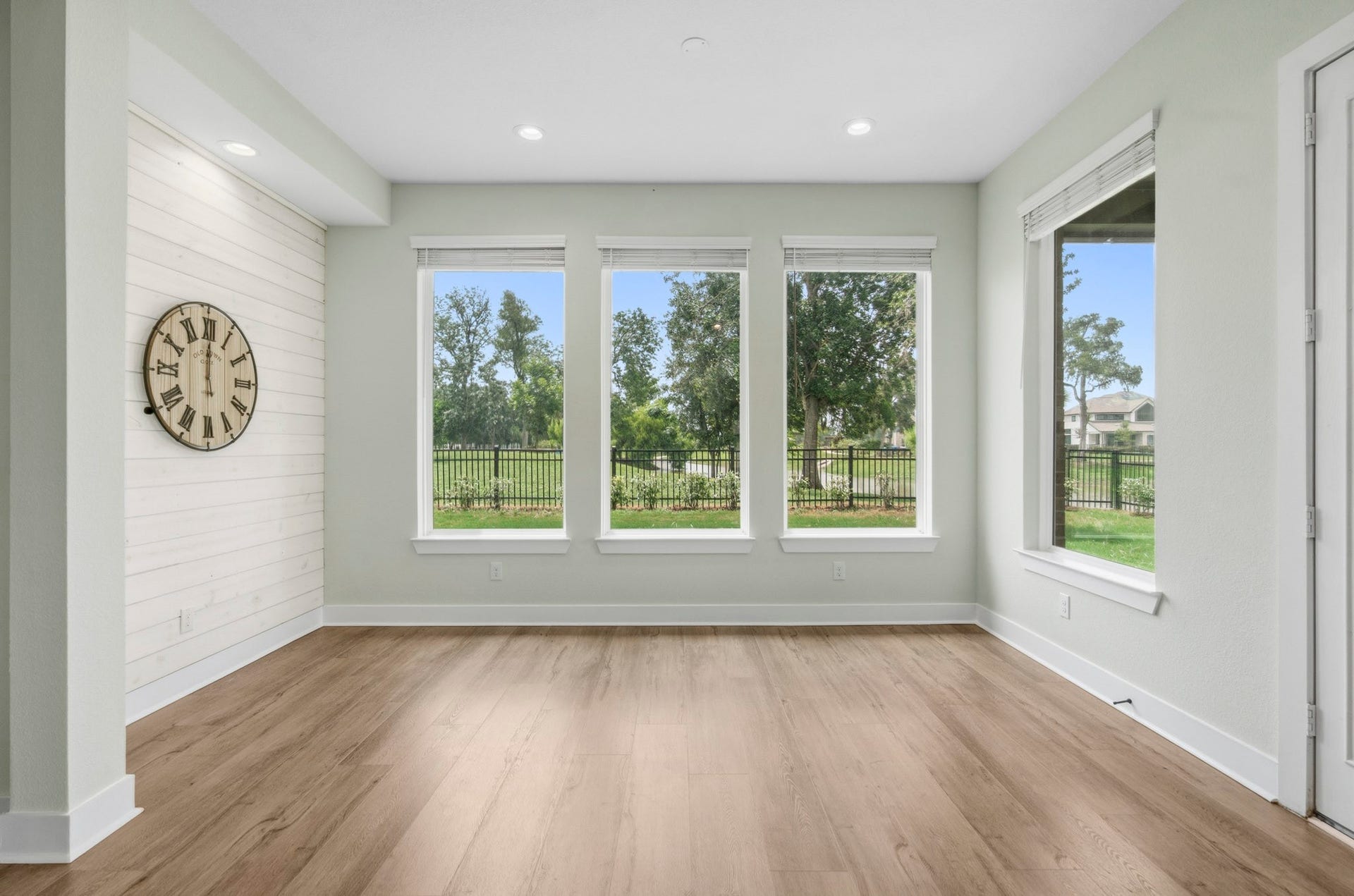 The Kitchen flows to this stunning Dining Room the offers a custom shiplap wall that softens. Its a space where the eye is drawn thru a quartet of huge plate glass windows that soothe the mind with spectacular viewswhere you can be lost in thought listening to the songbirds while watching the squirrels at play.