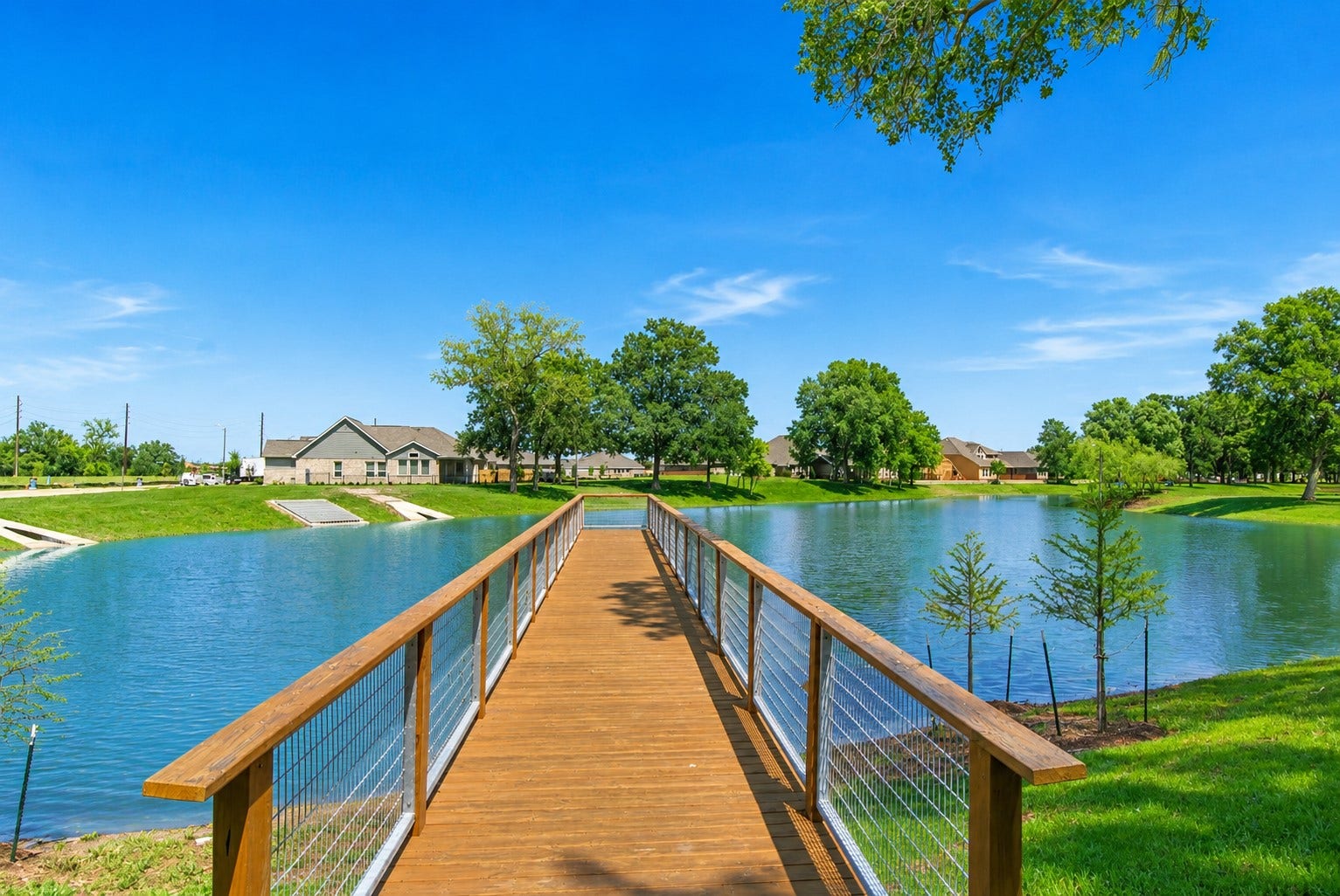 The home is on the left and is located directly across from both this fabulous fishing pier, that is both a picturesque focal point and a unique neighborhood amenity, that offers a daily reminder of the tranquil lakefront lifestyle that makes this home so special.