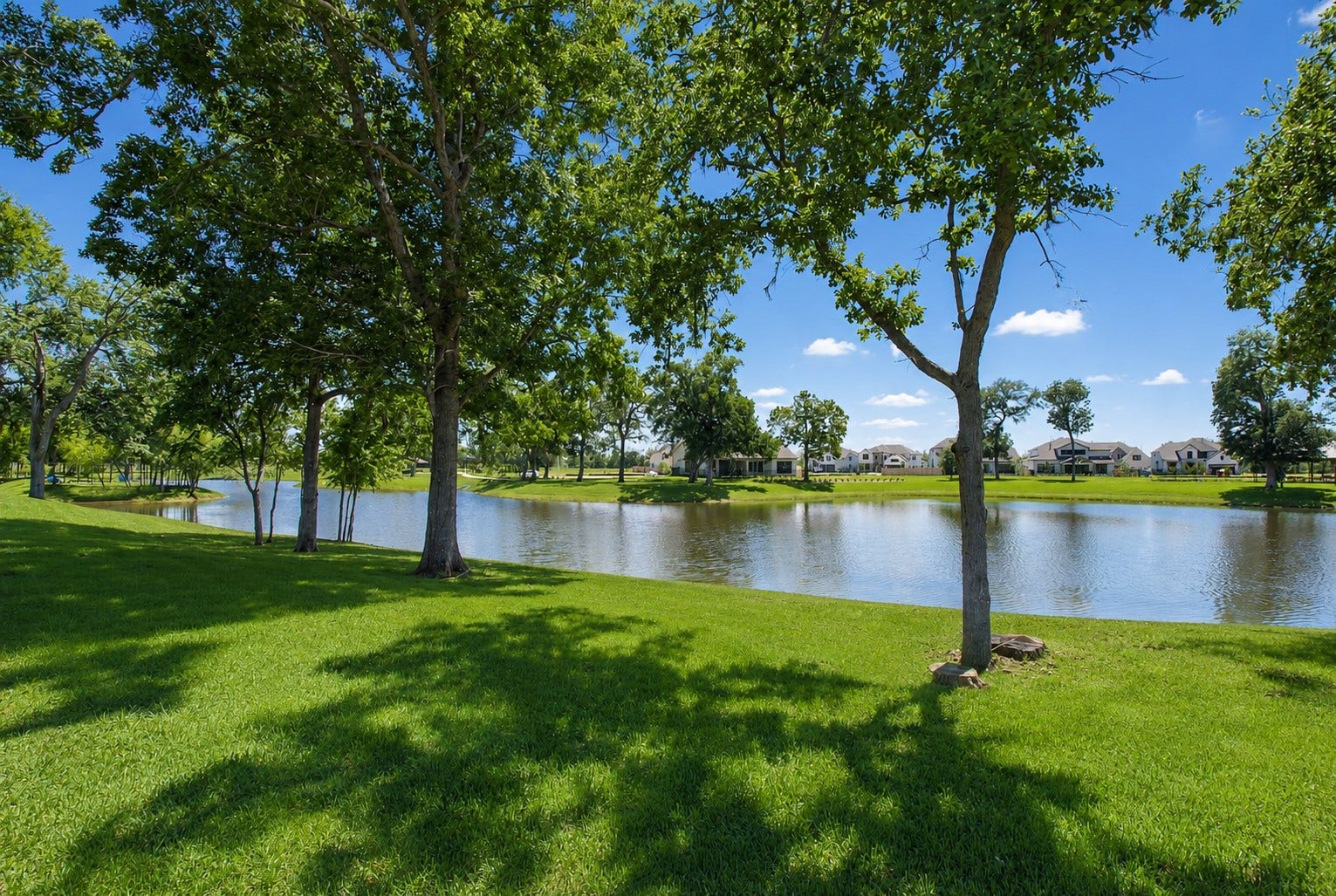 The home backs to gorgeous Sheffield Lake that is wonderfully shaded by the canopy of mature trees lining its banks, creating a serene and picturesque setting. The combination of tranquil water views and abundant natural shade makes it an ideal spot to relax, enjoy a picnic, or simply take in the beauty of the expansive landscape.