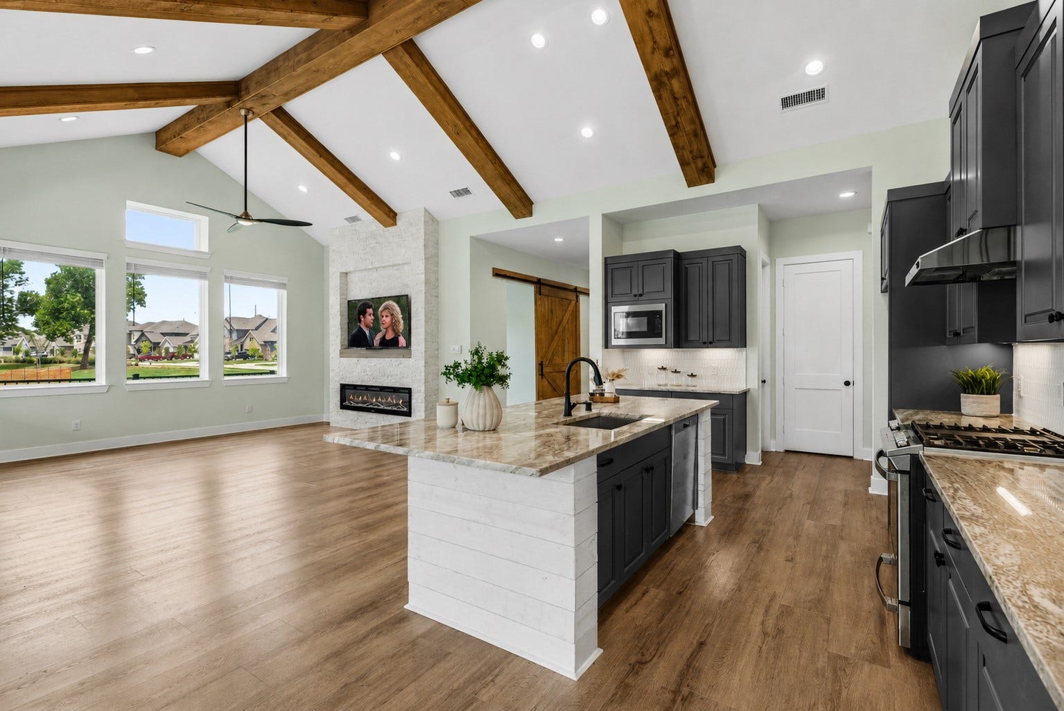 This is looking at the back of the Island that includes the under-mount sink and the whisper quiet stainless steel dishwasher that is part of the GE appliance package which also includes a 4-burner gas range with an integrated griddle, an oven with storage drawer below and a built-in microwave.