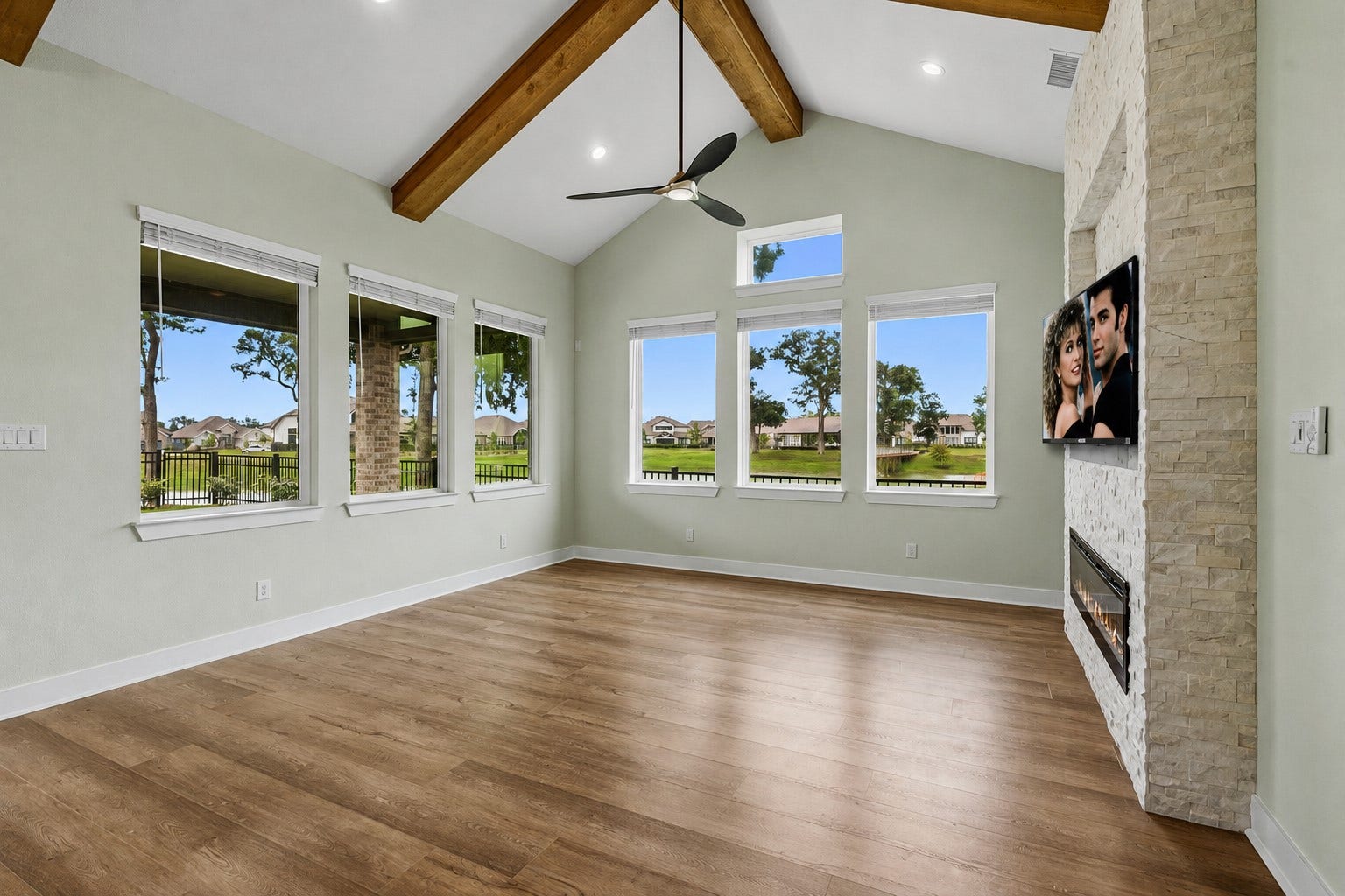 The extraordinary Family Room is dramatic with walls of stunning panorama views that also drench the room in natural light thru six huge picture windows that enhance the sense of openness and grandeur. This inviting space seamlessly connects the indoors with the natural beauty beyond, creating a serene and picturesque backdrop for both everyday living and entertaining.
