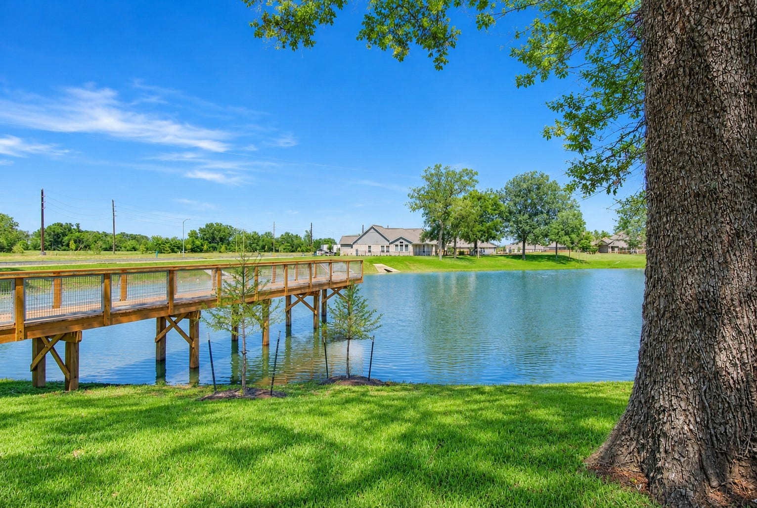 You will not find this view anywhere else. This photo captures a view of the home (in the distance on the far left) and showcases this remarkable pier that extends far out into the lake and is ideal for fishing or simply watching an afternoon sunset with a kaleidoscope of colors reflecting off the water.