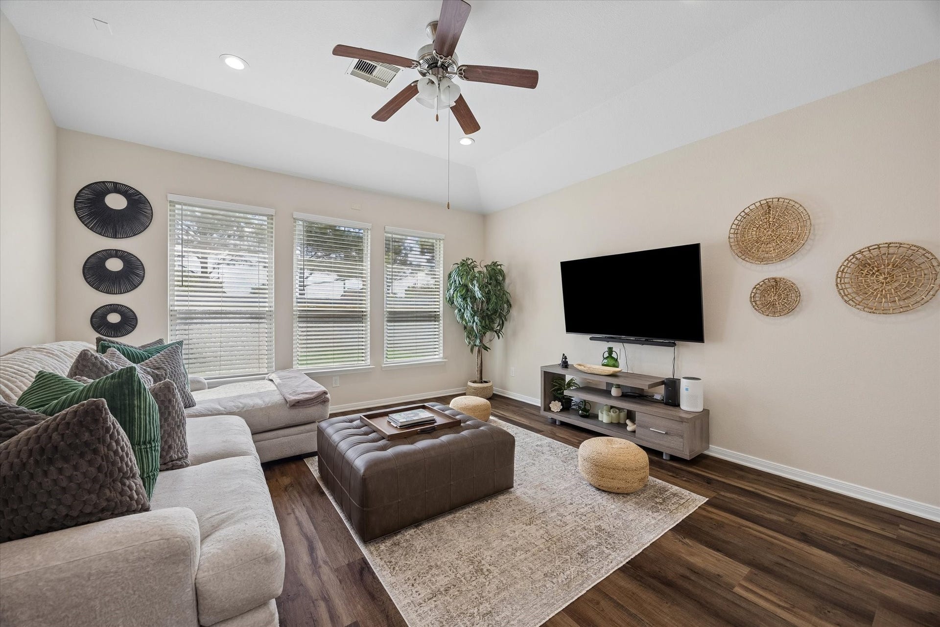 Spacious living room with LVP flooring and abundant natural light