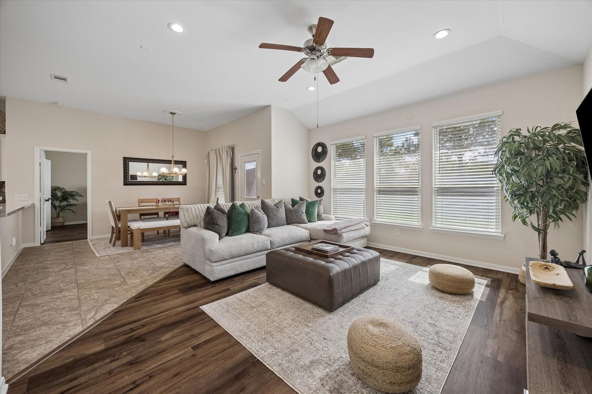 Open concept living area with large windows overlooking the backyard