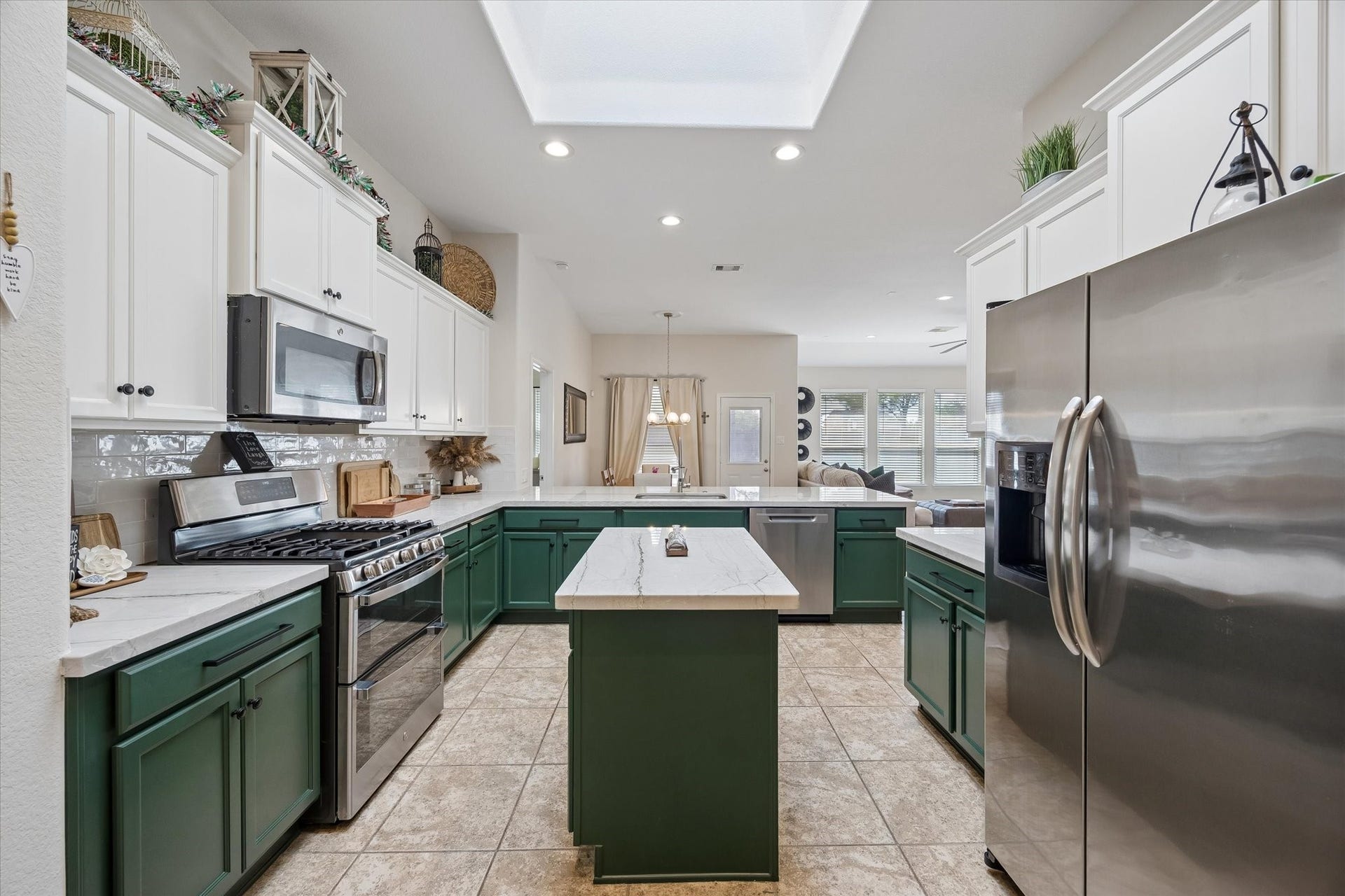 Kitchen with two-toned cabinetry, and stainless steel appliances