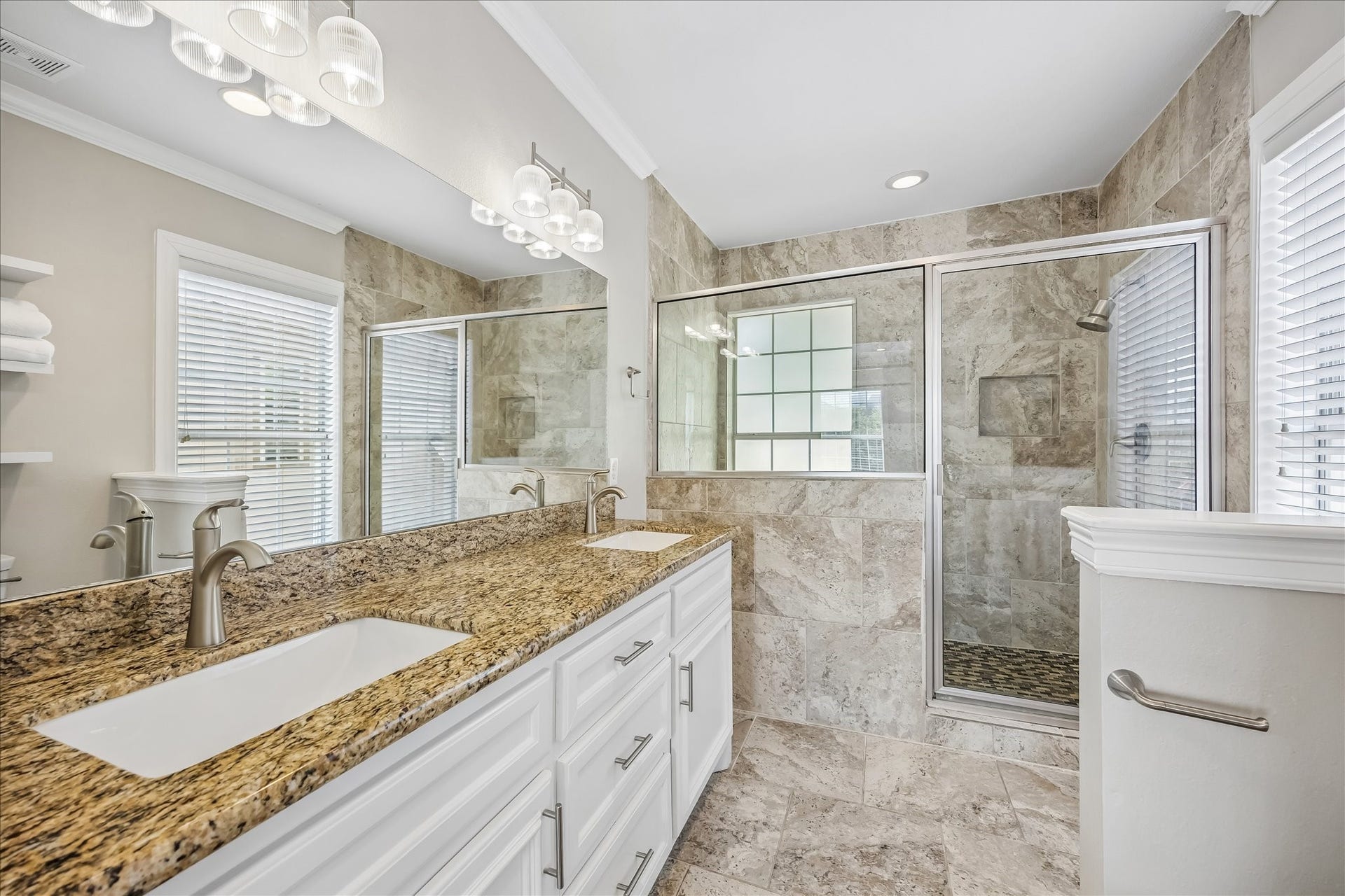 1909 Rosewood Street, Houston, TX 77004 Primary bath features dual sinks, granite counters, generous cabinetry, and a large glass-enclosed shower.