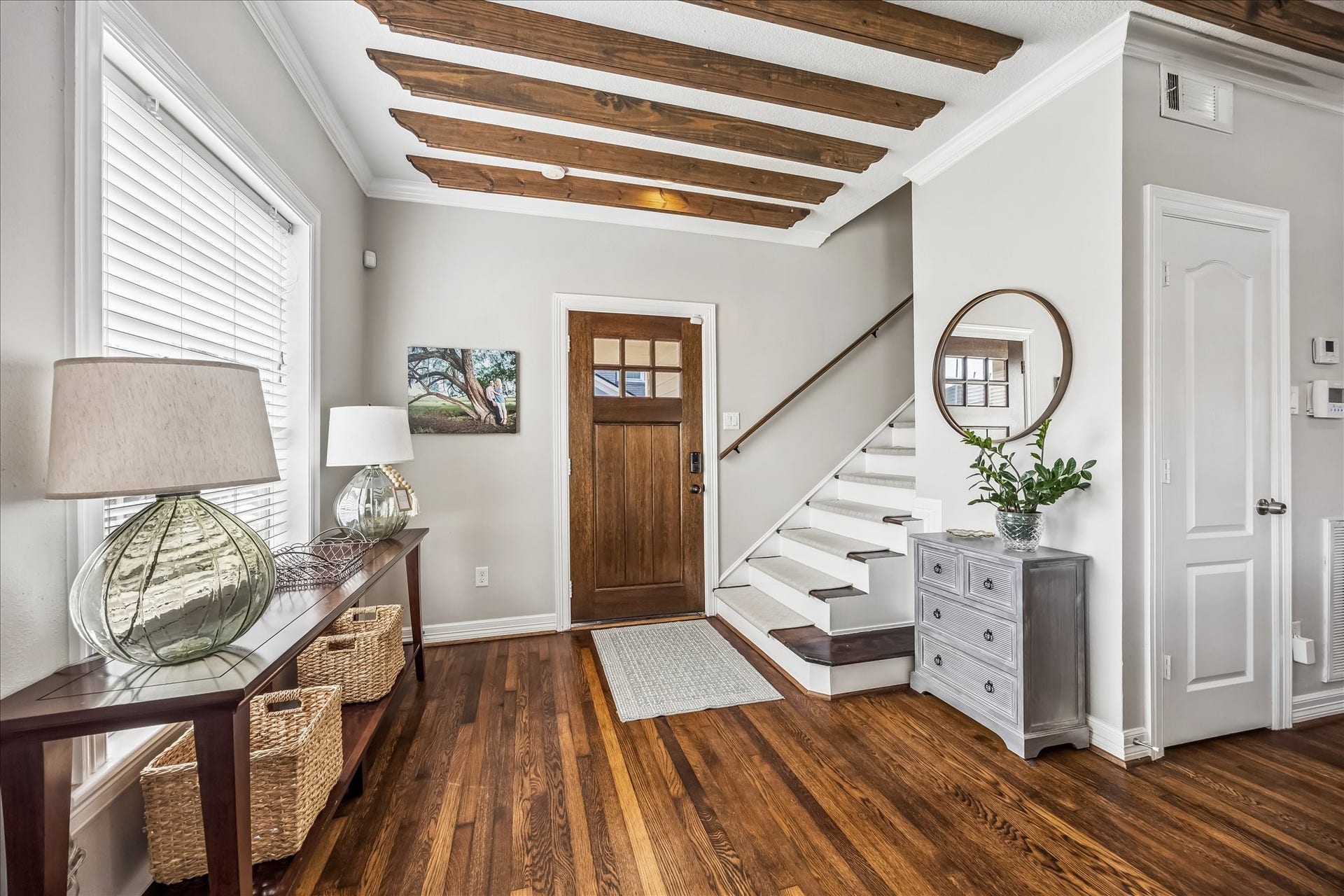 1909 Rosewood Street, Houston, TX 77004 Custom front doors installed in 2020 open to warm wood floors and a staircase finished with custom treads in 2023.