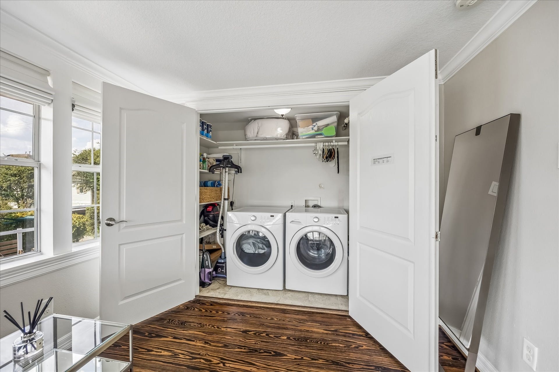 1909 Rosewood Street, Houston, TX 77004 Dedicated utility room keeps laundry tucked away upstairs, with a side-by-side laundry setup, storage, and a window bringing in natural light.