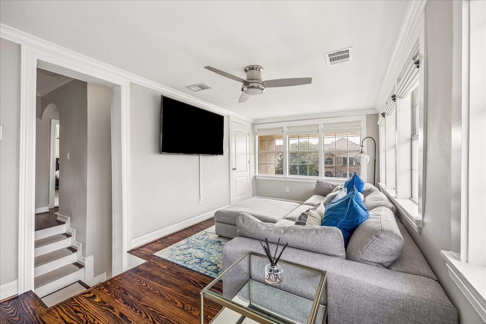 1909 Rosewood Street, Houston, TX 77004 Upstairs family room creates a separate everyday living area, with windows on two sides, wood flooring, and room for a comfortable seating arrangement.