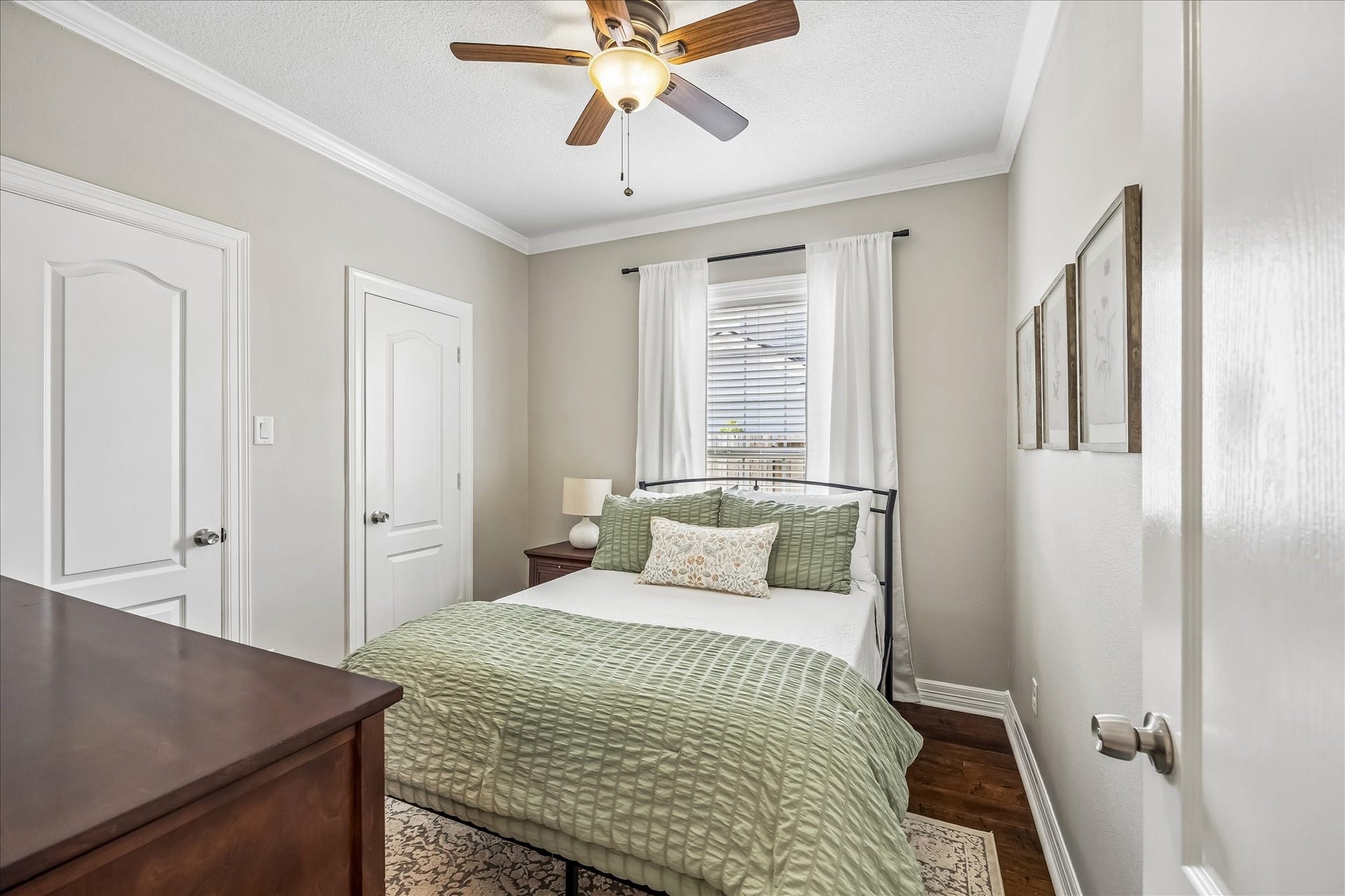 1909 Rosewood Street, Houston, TX 77004 Secondary bedroom downstairs is finished with original hardwood floors refinished in 2020, crown molding, and windows on two sides.