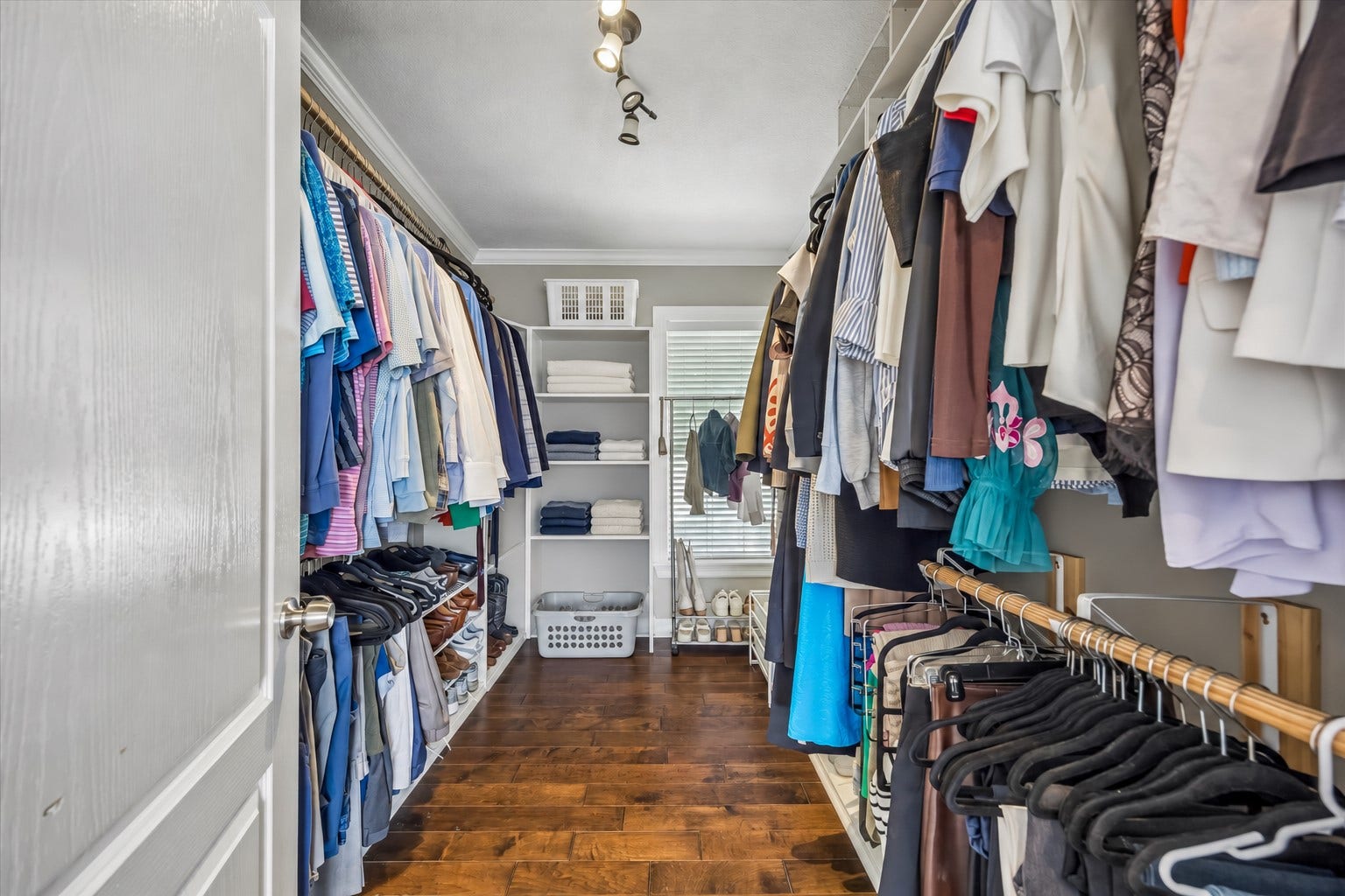 1909 Rosewood Street, Houston, TX 77004 Walk-in closet provides long runs of hanging space, shoe storage, and built-in shelving while keeping everything neatly organized.