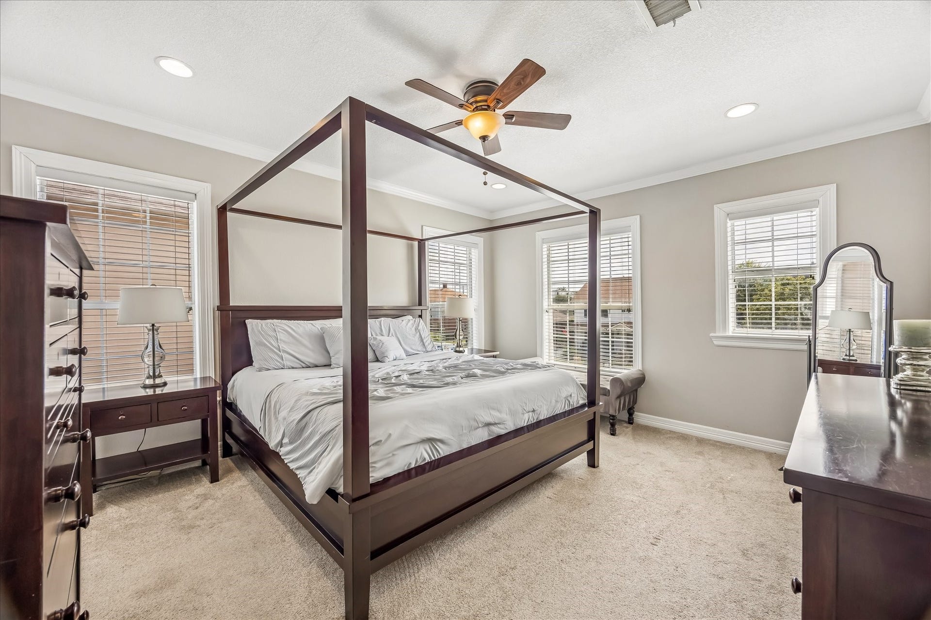 1909 Rosewood Street, Houston, TX 77004 Spacious primary suite offers soft natural light, room for substantial furniture, and a ceiling fan overhead.