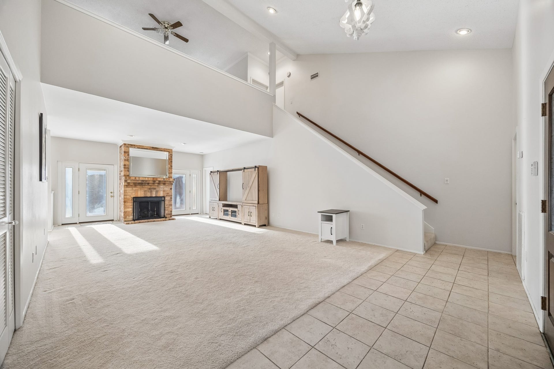3902 Crystal Falls Drive, Missouri City, TX 77459 Spacious living room with soaring ceilings and a brick fireplace.