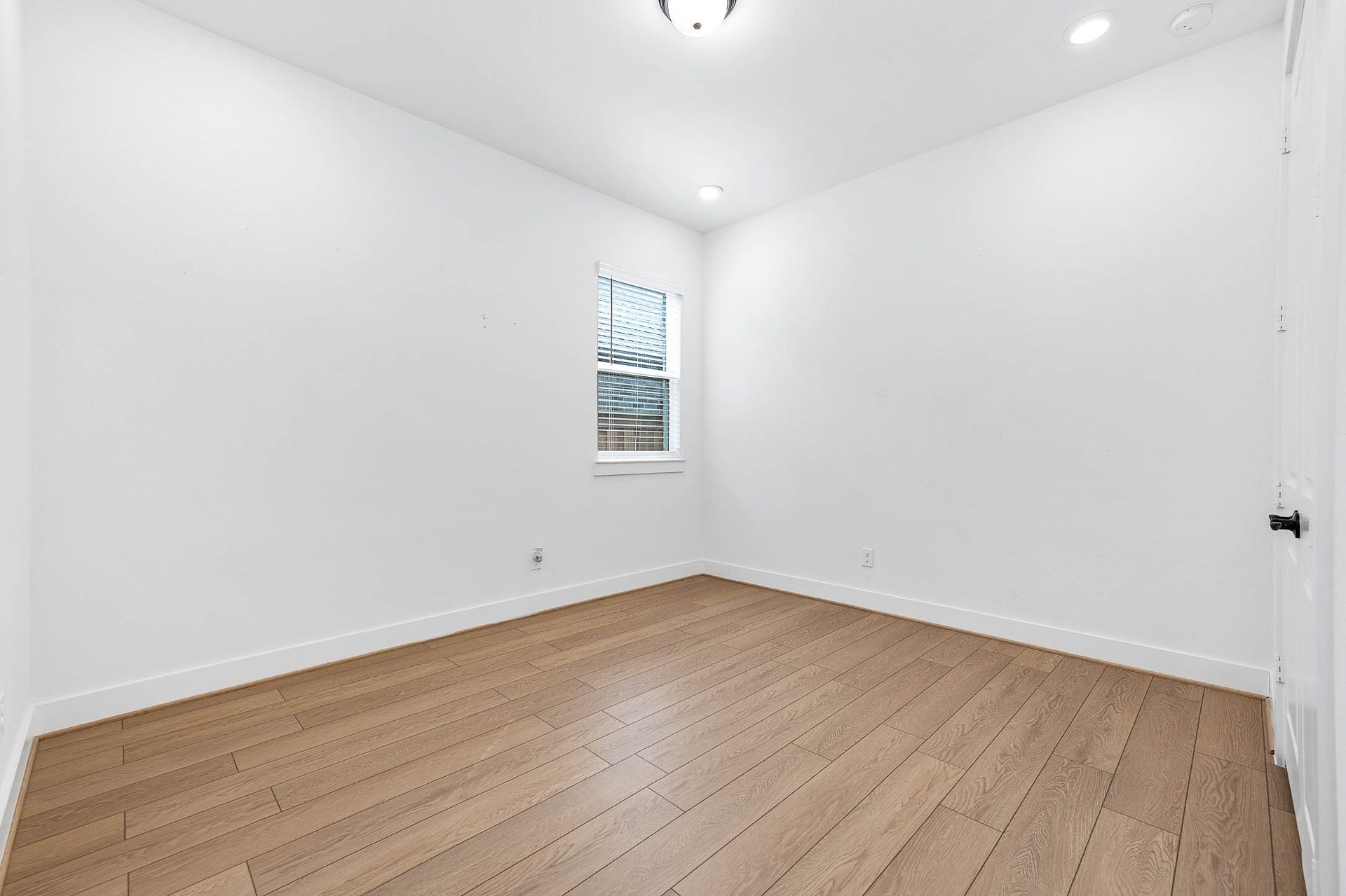 13802 Arroyo Grande Drive, Cypress, TX 77433 Versatile secondary bedroom with wood-look flooring and neutral finishes.