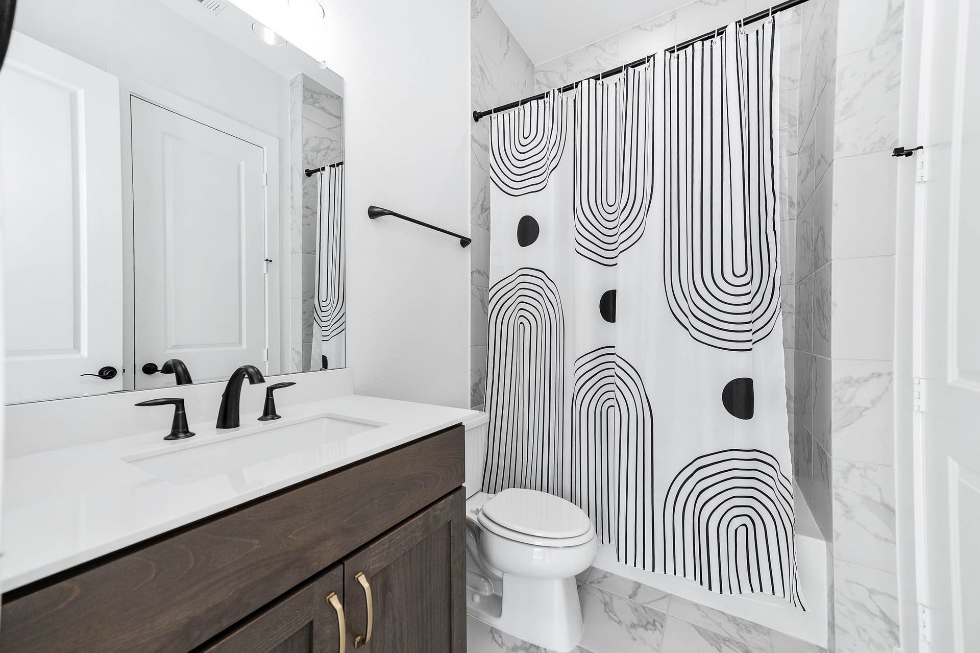 13802 Arroyo Grande Drive, Cypress, TX 77433 Stylish guest bathroom featuring a tub/shower combo and elegant fixtures.